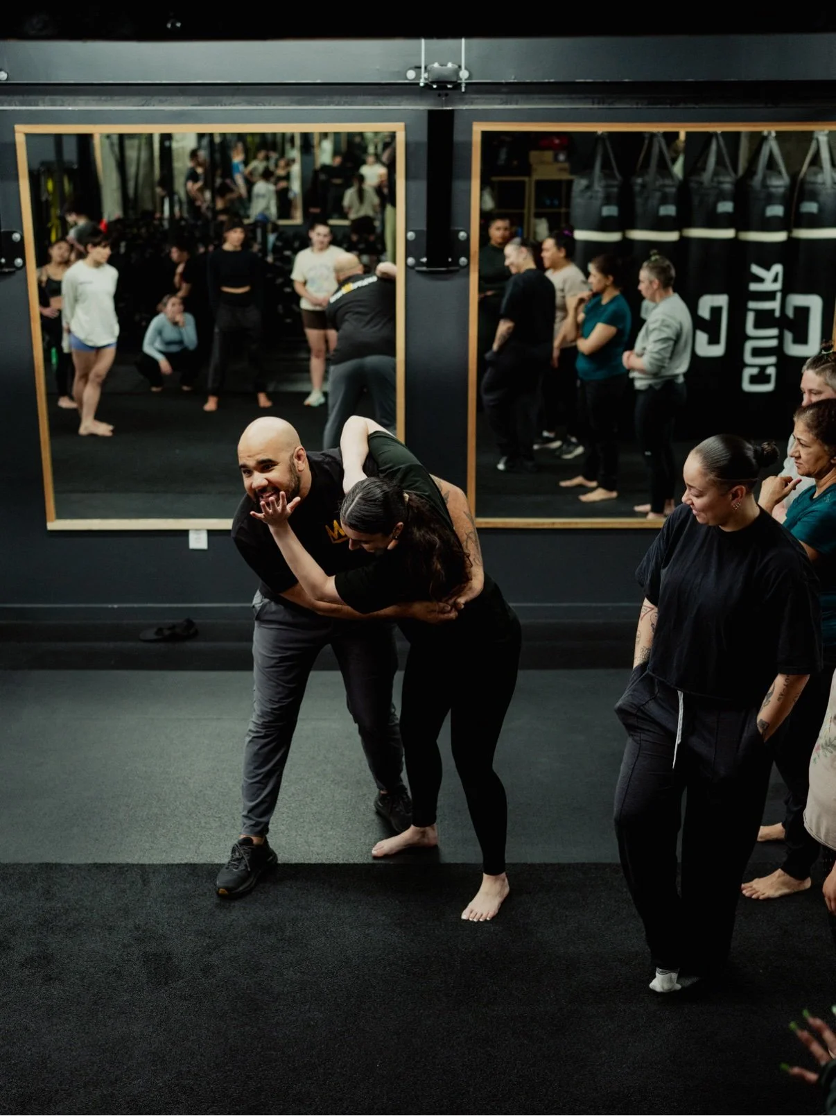 Chris demonstrating a clinch escape technique with a participant during a live Defensive Tactics safety seminar