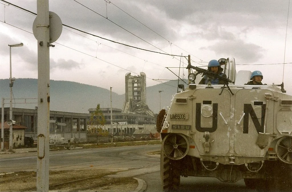 UN troops on their way up “Sniper Alley” in Sarajevo. From Wikipedia .