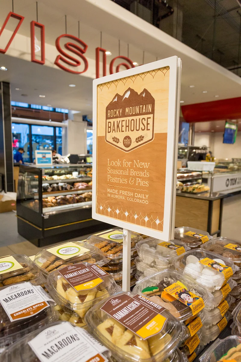 Wood veneer print and cut out signage at the opening of the Union Station, Denver Whole Foods Market.