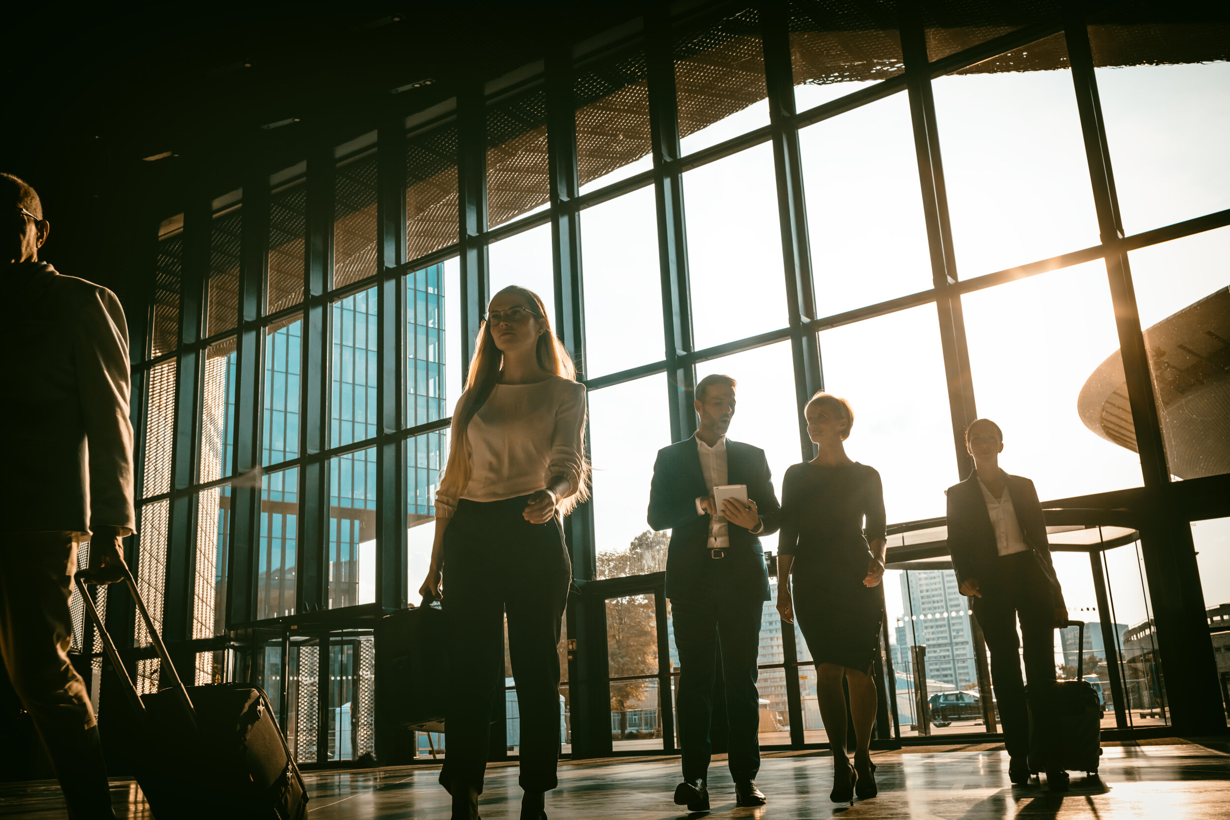 group-of-business-people-walking-in-airport-hall-67WV6VR.jpg