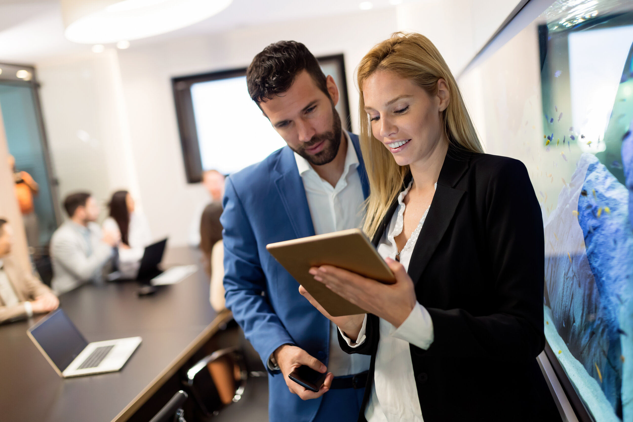 attractive-business-couple-using-tablet-in-their-c-QJ5DPLK.jpg