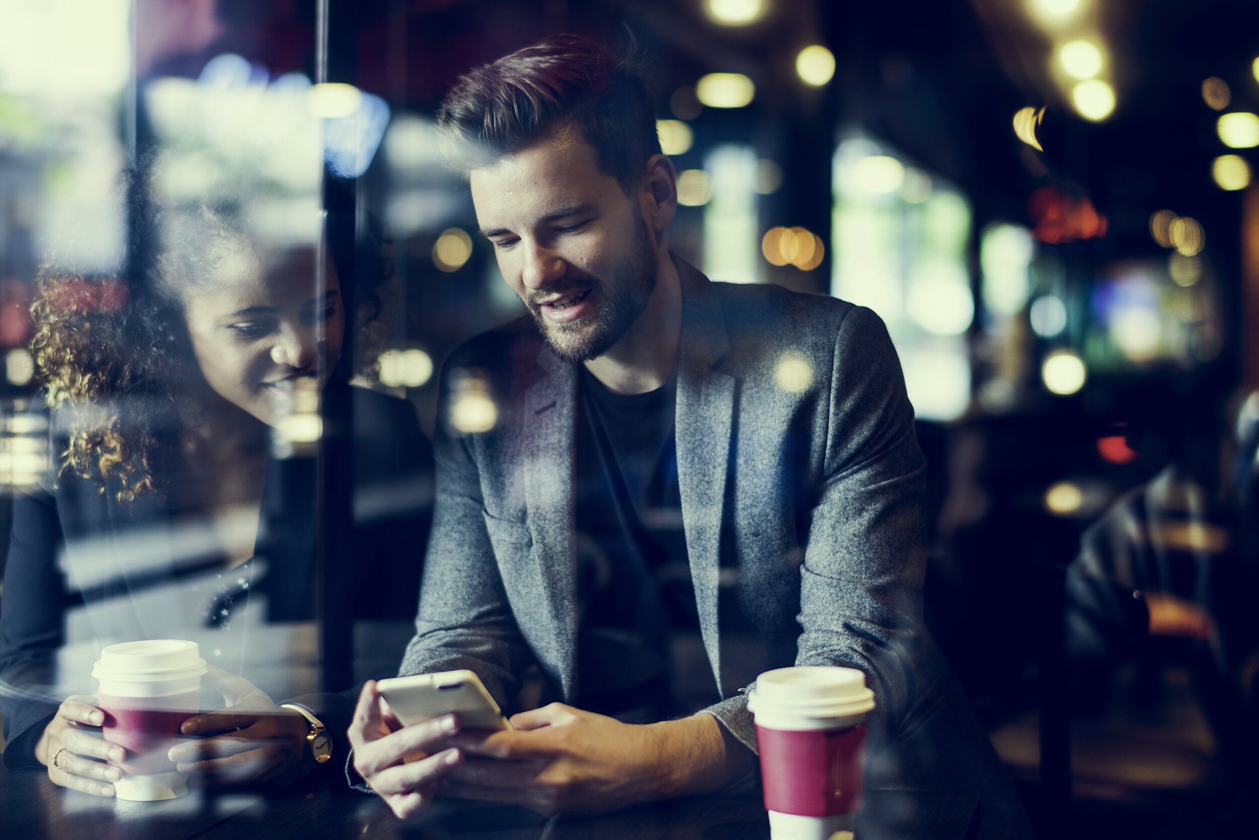 casual-man-using-mobile-phone-in-the-cafe-P63WBUA.jpg
