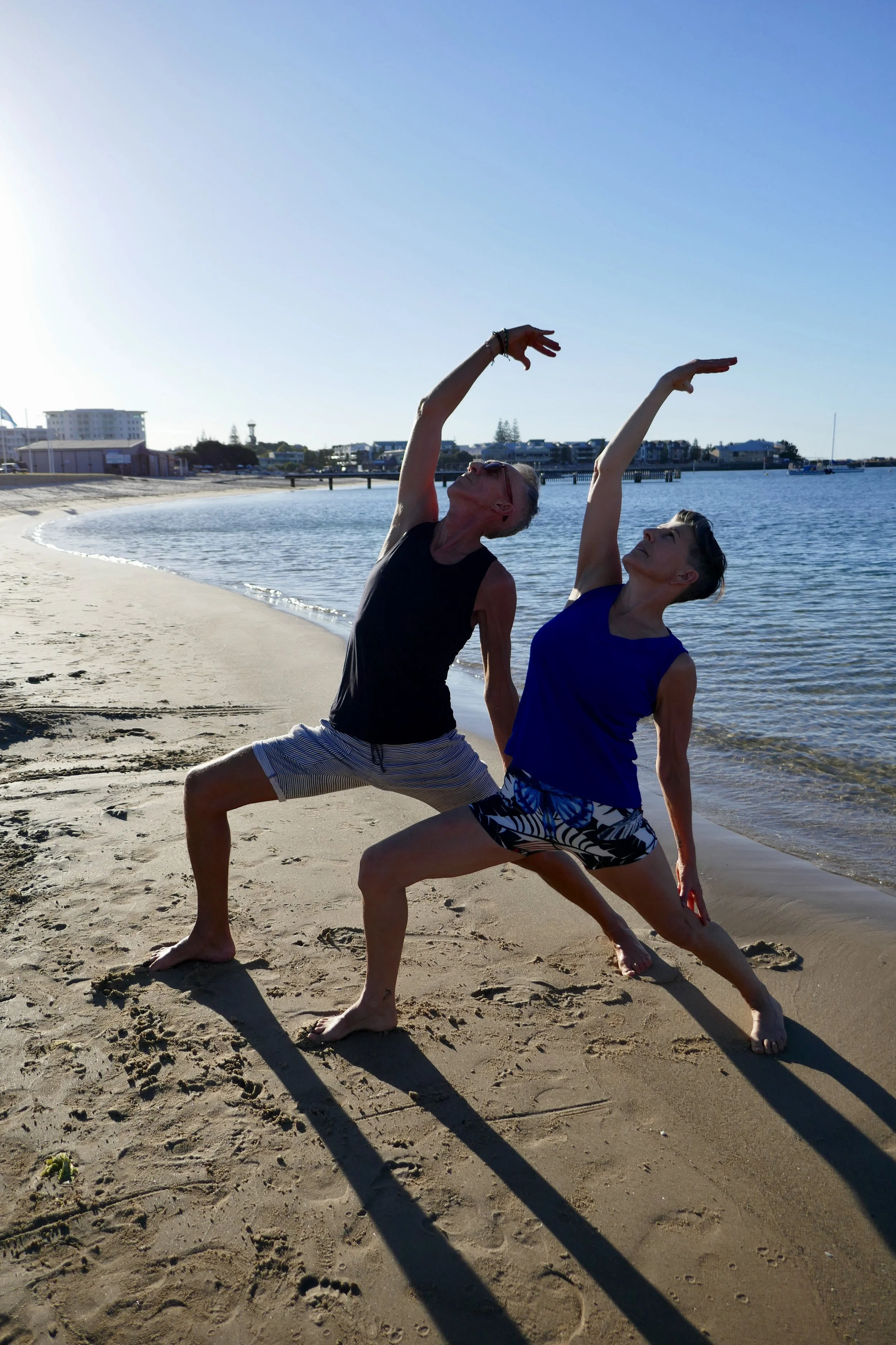 Donelle and John practising Yoga on the beach in Bunbury