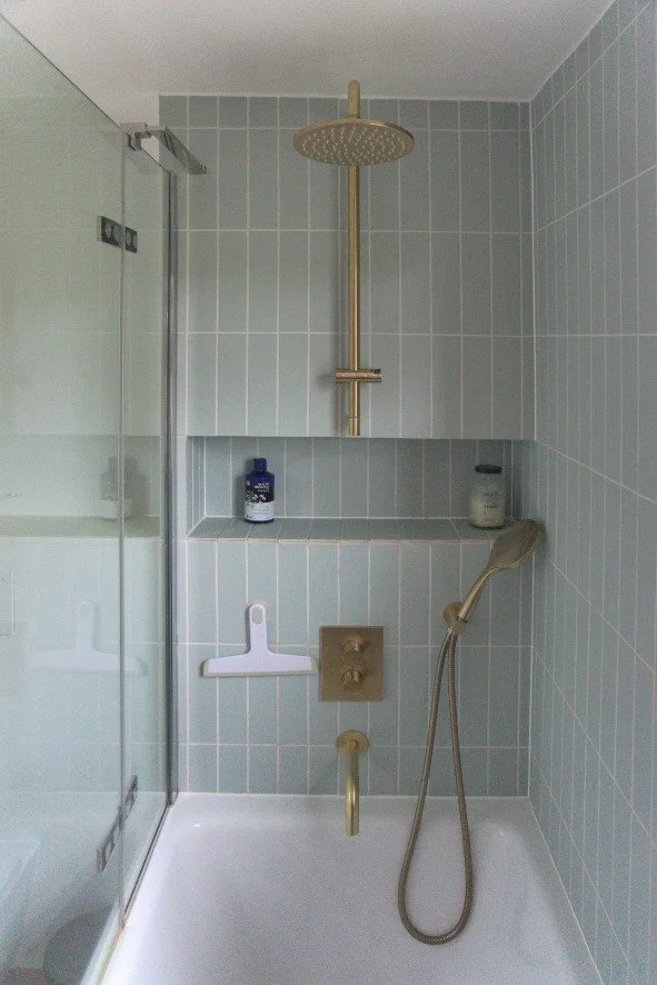 Tiled recess in shower.