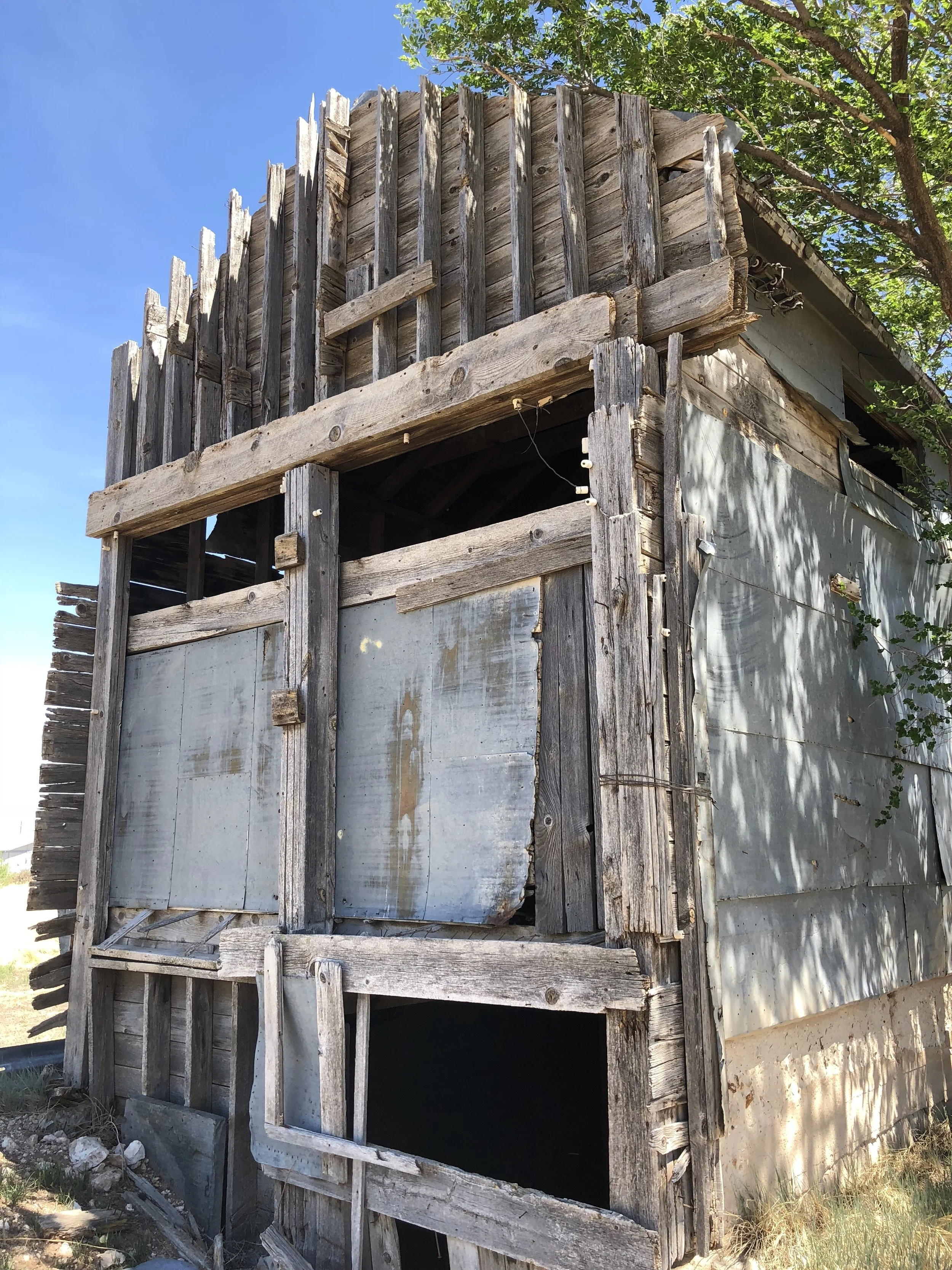 This unique building is from the period around 1912. The Florsheim Mercantile Co. were said to be the original builders. It was used to store grain, wheat and beans for shipment by train. It sat next to the railroad spur in Roy, NM. We were able to reclaim some beautiful greyed wood behind the galvanized siding sheets and large sliding barn doors from the sides and front. All with original hardware. Flooring was old growth Douglas fir. Roughcut Douglas fir beams. Heavy galvanized roof panels and sheeting. Shiplap roofing.