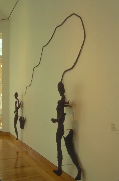 MODERN TIMES: DOUBLE SELF PORTRAIT CONCERNING EXORCISM AND LEAPING 1993-94 Kelp, glue, wood, wax, fabric, and shellac, 14' W x 9.5' H x1'D, Side view.