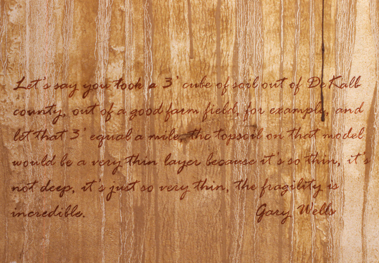  View of walls stained with local pigments and lettered with text from Gary Wells interview. 