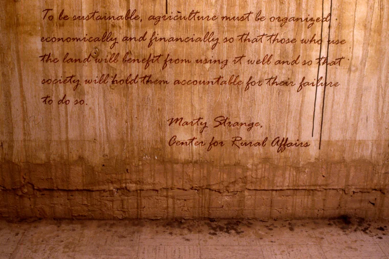 View of walls stained with local pigments and lettered with text from Marty Strange, Center for Rural Affairs.