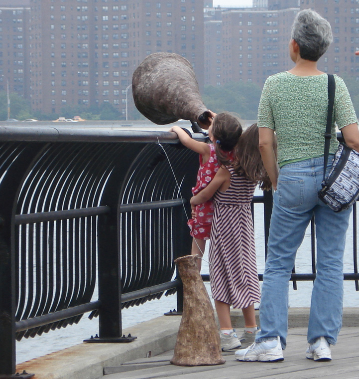  Child lifting child to see the framed view of Brooklyn Bridge. 