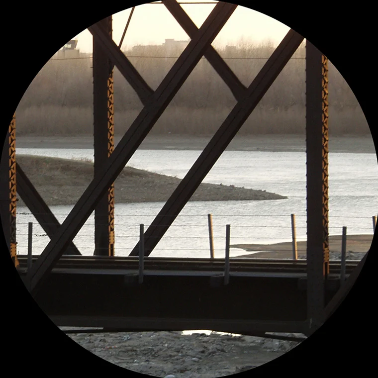 View of Confluence Station, view of the confluence of the Missouri and Kansas Rivers (through a railroad bridge). Photo: Tim Dalton