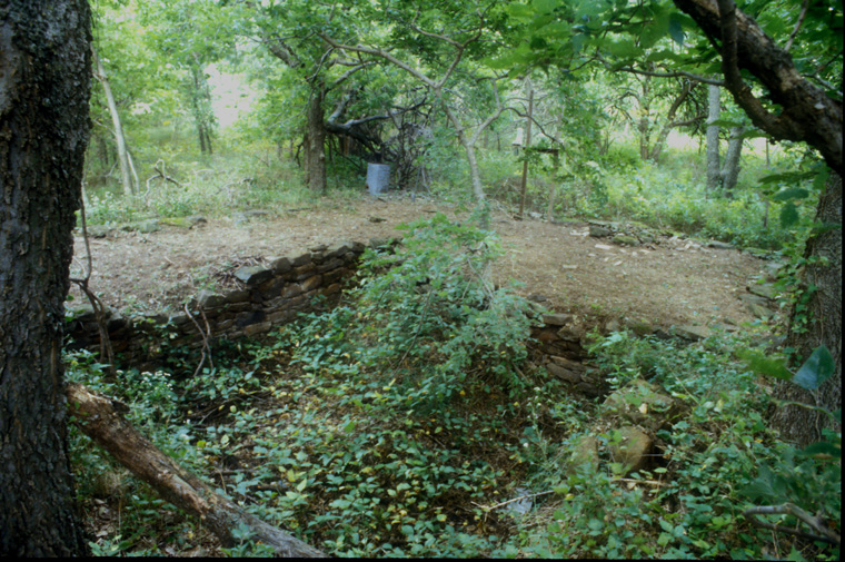  Cleared remains of drystone farmhouse cellar, with shelf containing hand and electric appliances, blender, electric mixer, electric can opener, whisk, grater, potato smasher and hand crank can opener. 