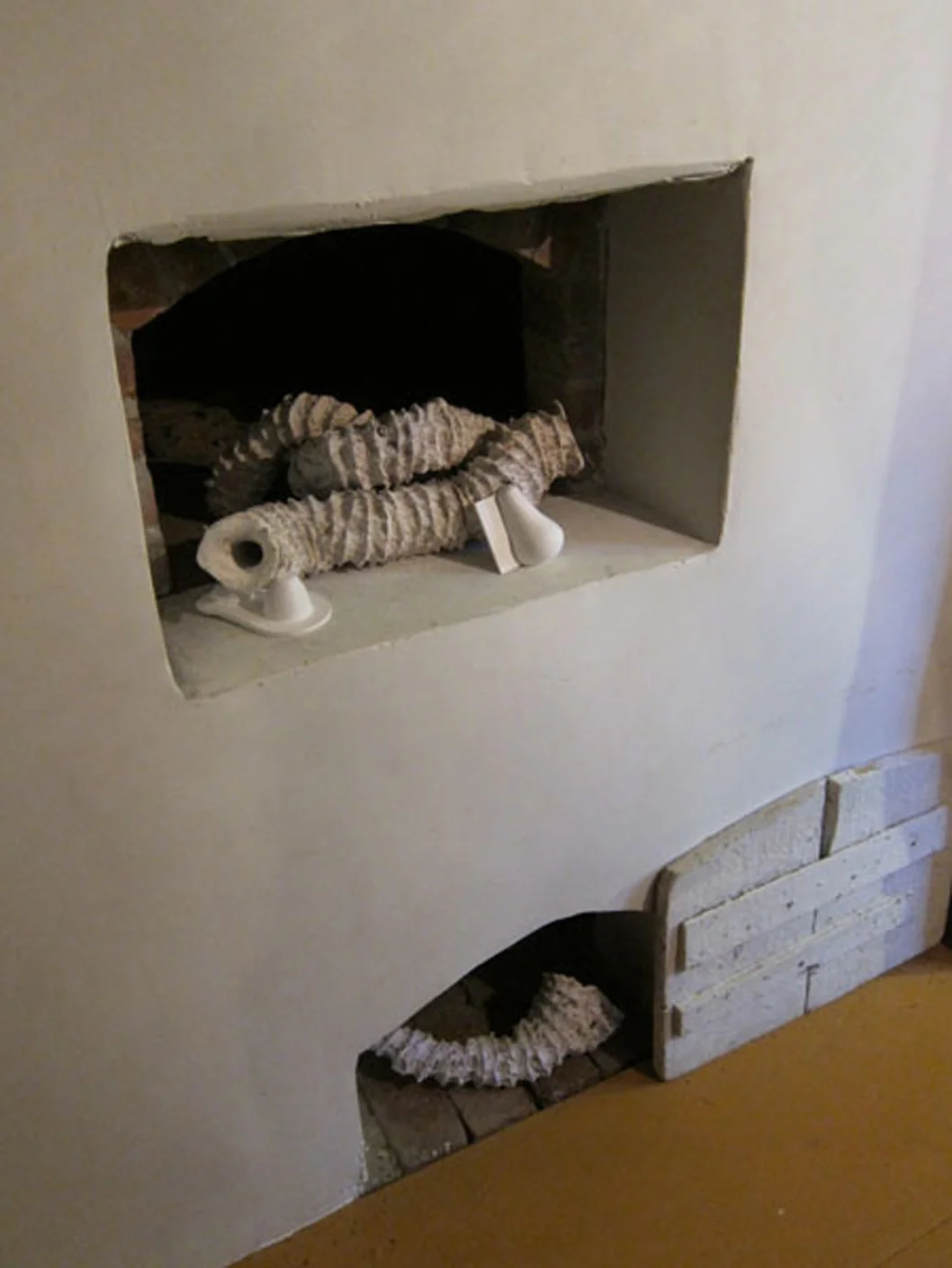 Seemingly Unconnected Events: Warming 2011 Wentworth-Coolidge State Historic Mansion Portsmouth, NH Installation in warming niches off the sunken brick kitchen near visitors entrance. Plaster casts of organic forms with casts into consumer goods packaging, “Seaworms” 2-3” diameter x 17” shortest and 37” longest; consumer goods life sized. 