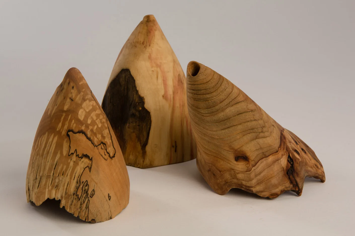 L-R, The Beak, Maple, beeswax. linseed oil, 4.25” diameter x 6.75” high, Dark Front, Box Elder, beeswax. linseed oil, 4” diameter x 7” high, and Elmo. Elm, beeswax. linseed oil, 5.5” diameter x 8.75” high Photography: Stacey Evans