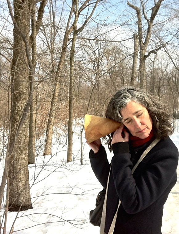  Lydia listening intently to the Loch, hand carved wooden burl trumpet in use, walk planned and led by Karen McCoy by invitation of the Walk Exchange, NY. (photo: Julius) 