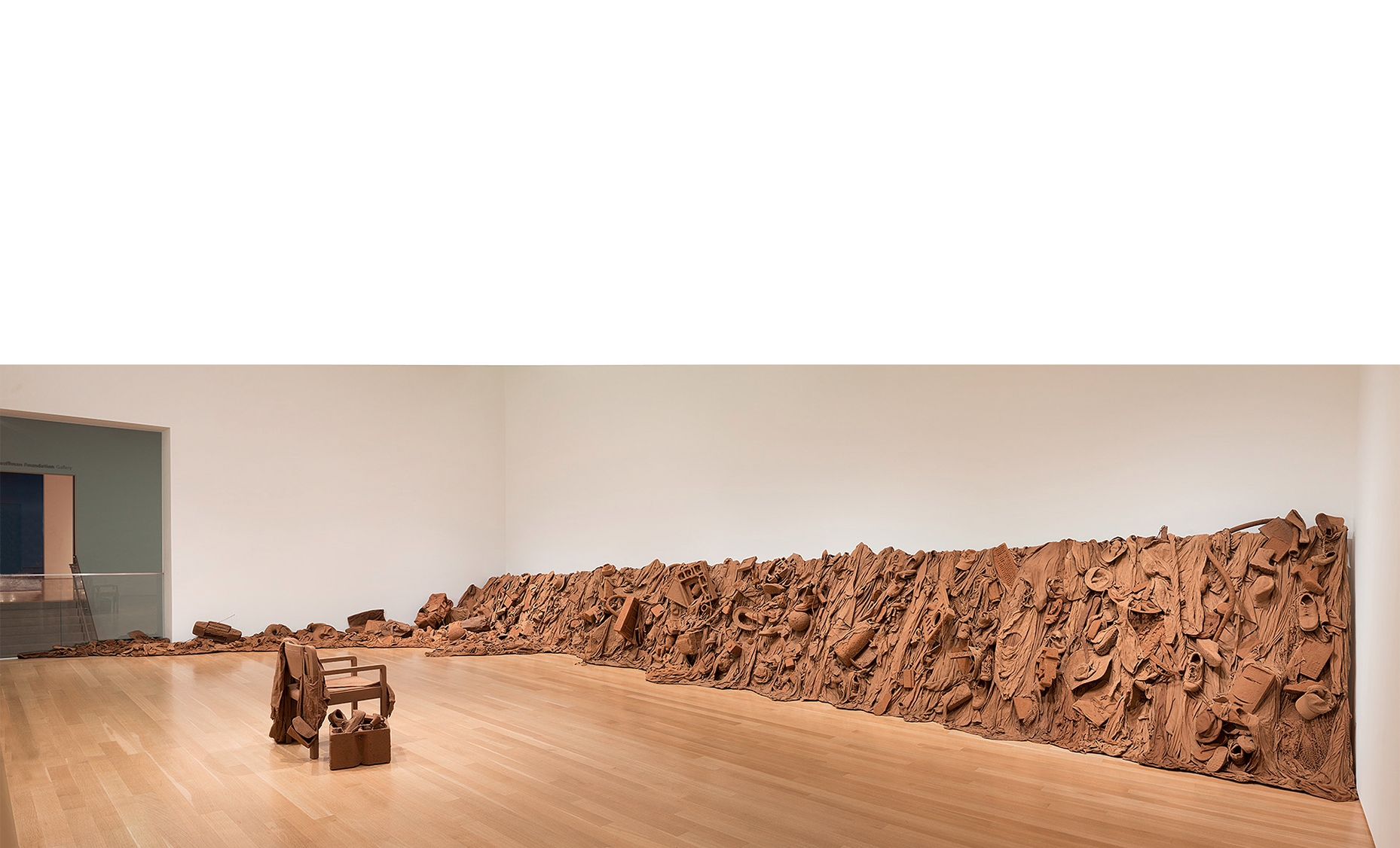  Overview,  Consuming Questions , 2017-18, an avalanche of consumer goods encased in Missouri red subsoil (clay) stabilized with PVA, wooden armature in 6 sections + floor sections. 