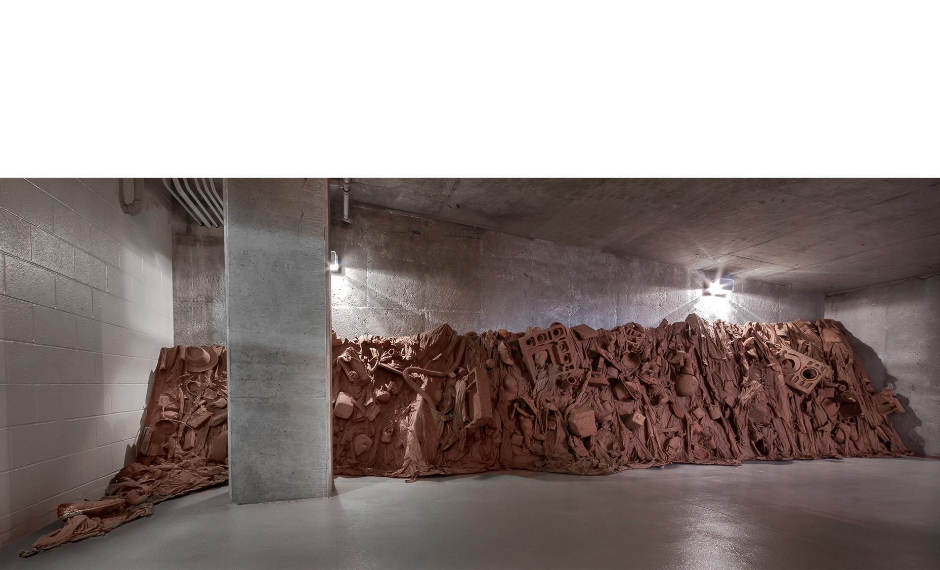 Consuming Questions 2016 contemporary consumer goods encased in red Missouri mud stabilized by PVA 26’l x 5’ average height x 40” d. Photos: E.G. Schempf