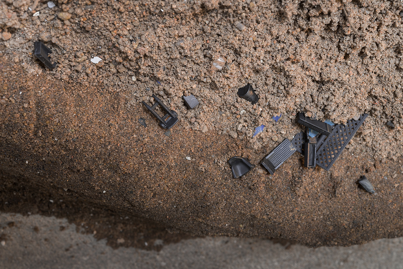  Detail: Debris on the Kaw, silt stabilized with sorghum syrup enclosing sand, HO scale train model objects, 100’L x 3” H and 14” average width 