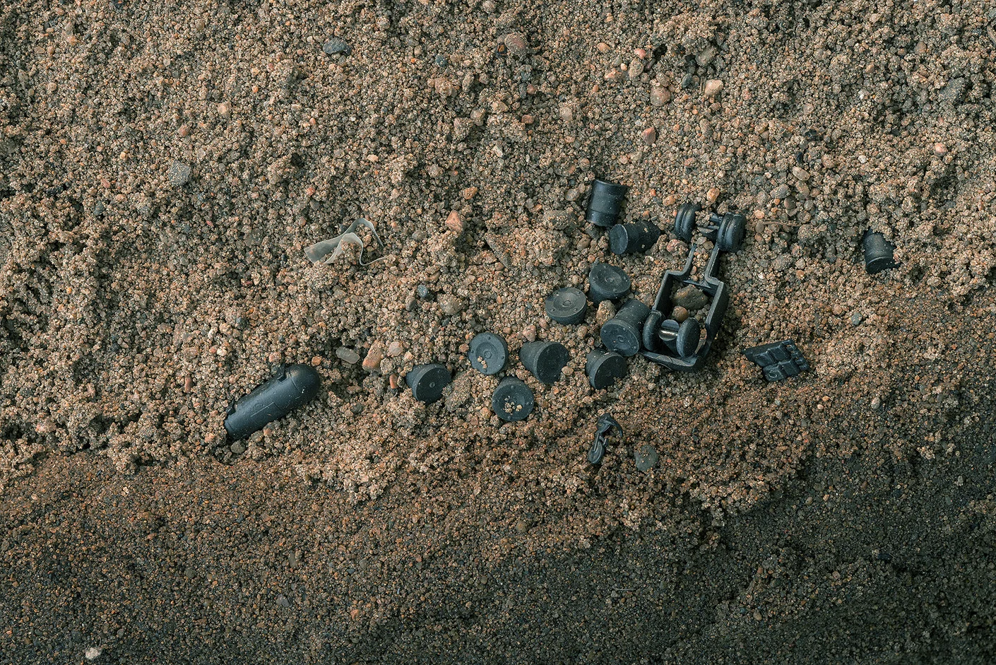 Detail: Tire debris, silt stabilized with sorghum syrup enclosing sand, HO scale train model objects, 100’L x 3” H and 14” average width