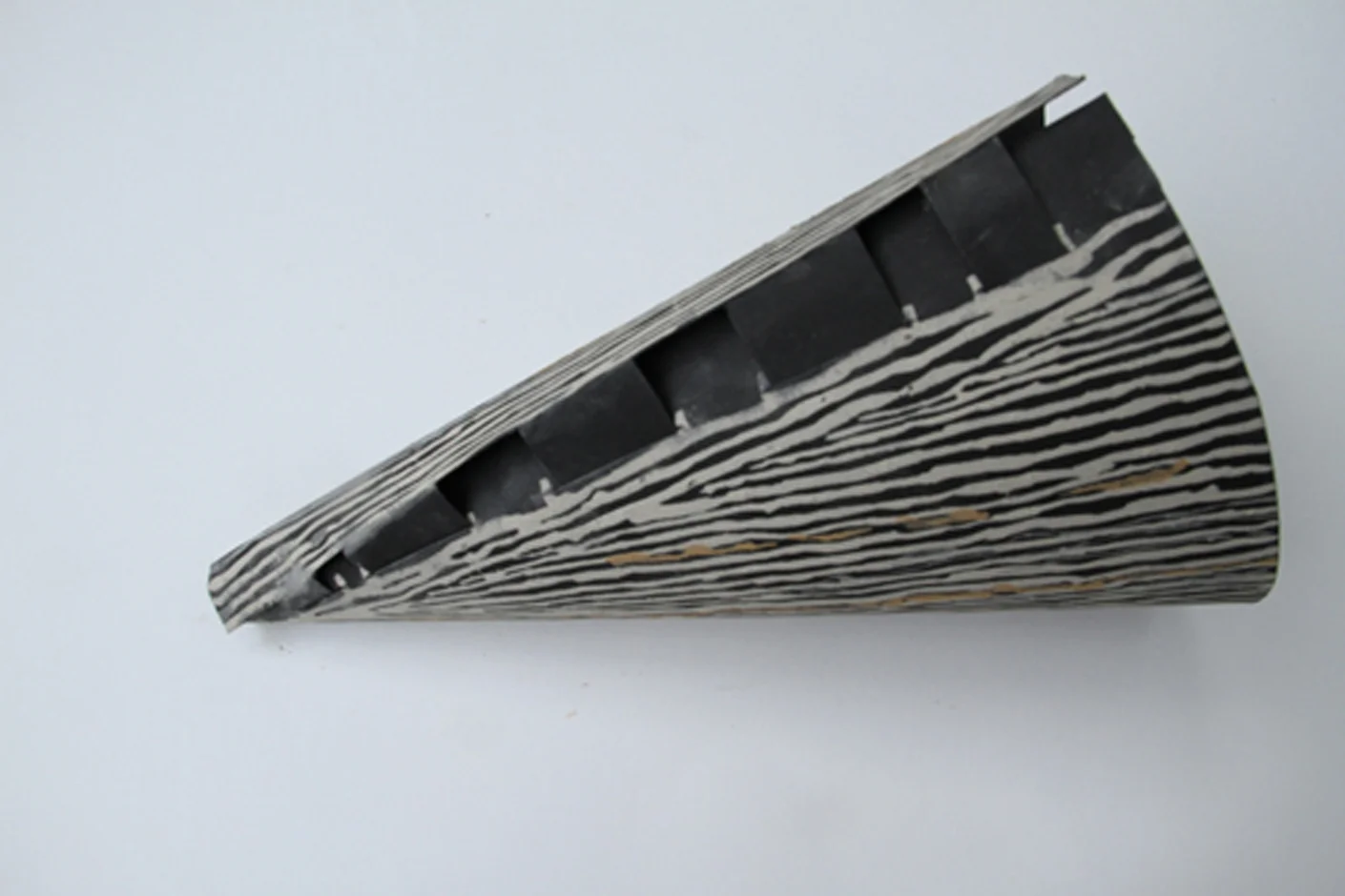 Print, Cut and Fold open source paper listening trumpet, 2014, original drawing with pigments found in Wales on black Stonehenge paper, shown rolled with tabs partially inserted in slots.