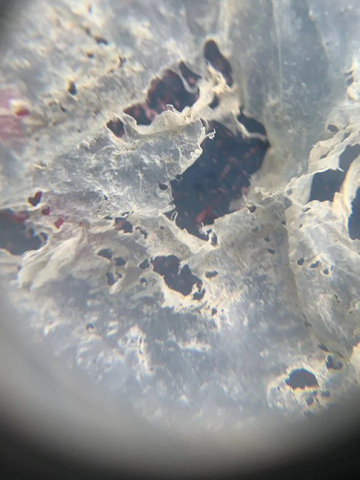 Another portion of the weathered plastic seen through the lens