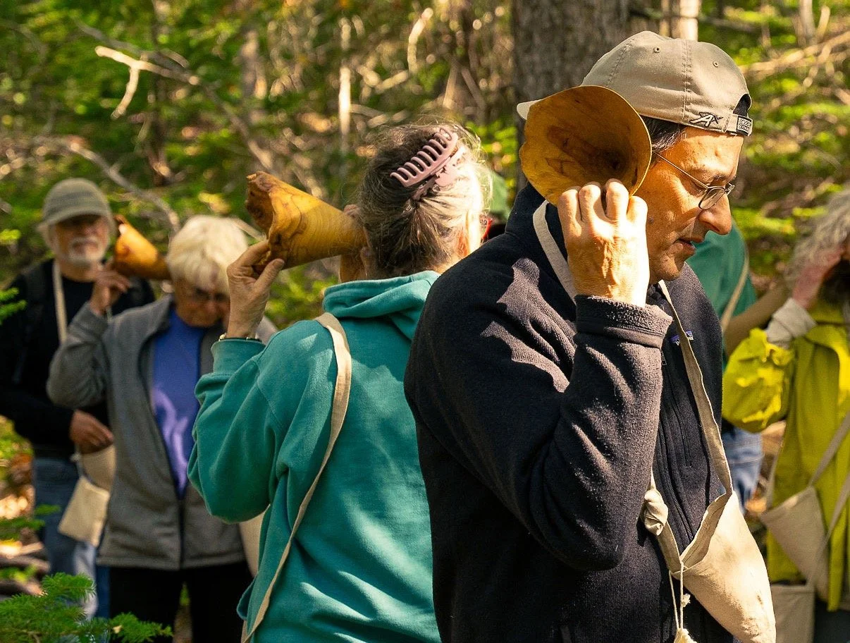  Participants listening with hand-carved wooden burl listening horns 