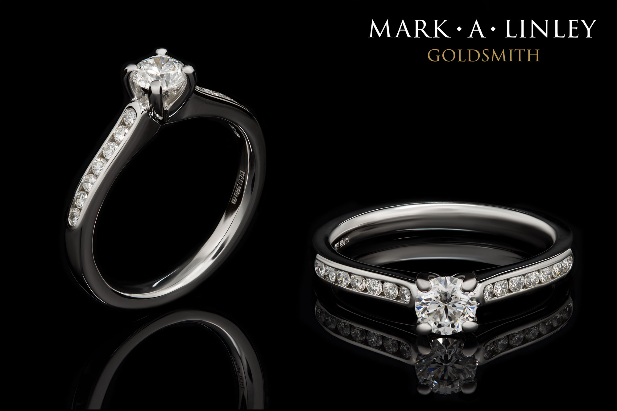 Platinum solitaire ring with diamond set shoulders