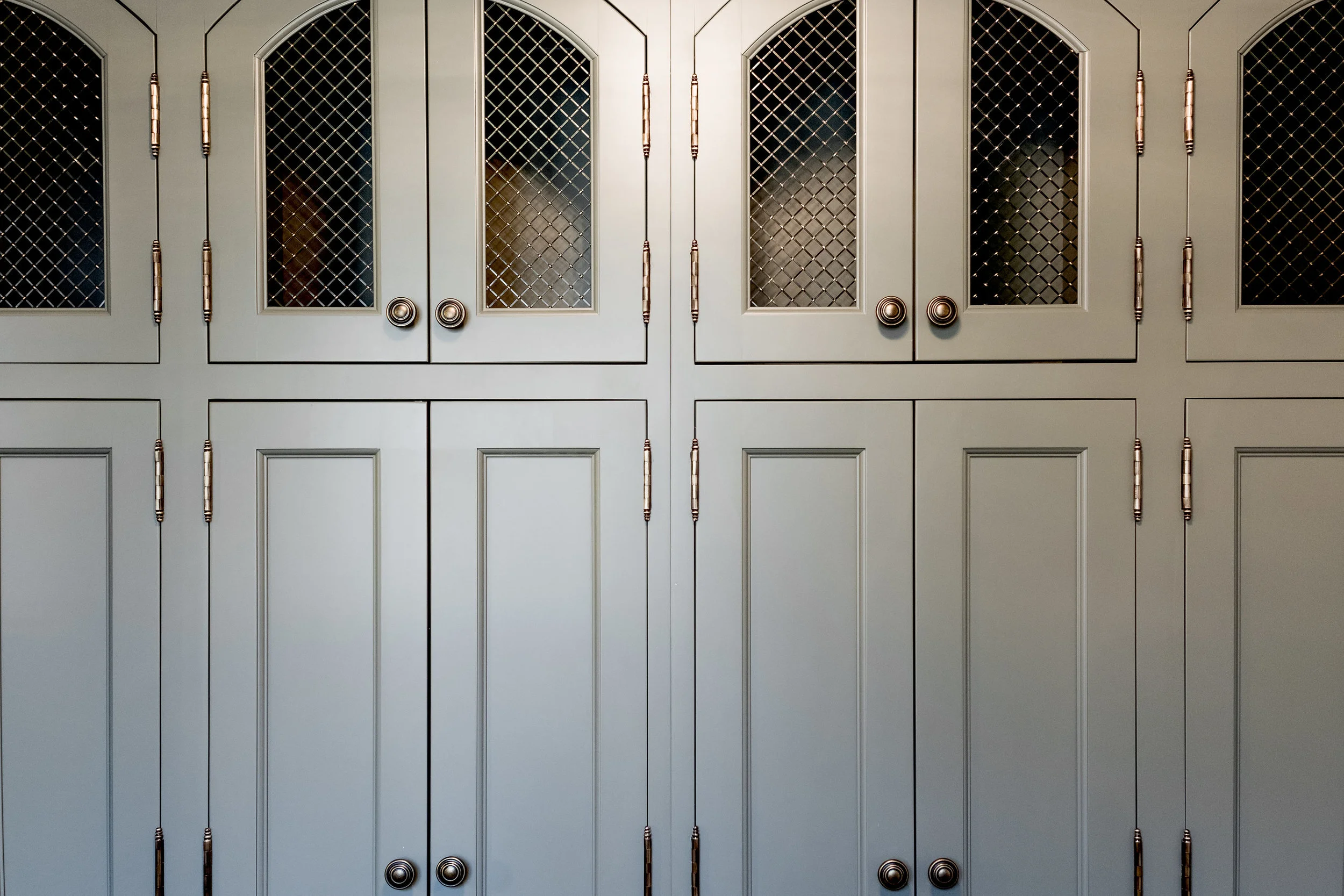 Grey/green custom cabinetry in farmhouse mud room