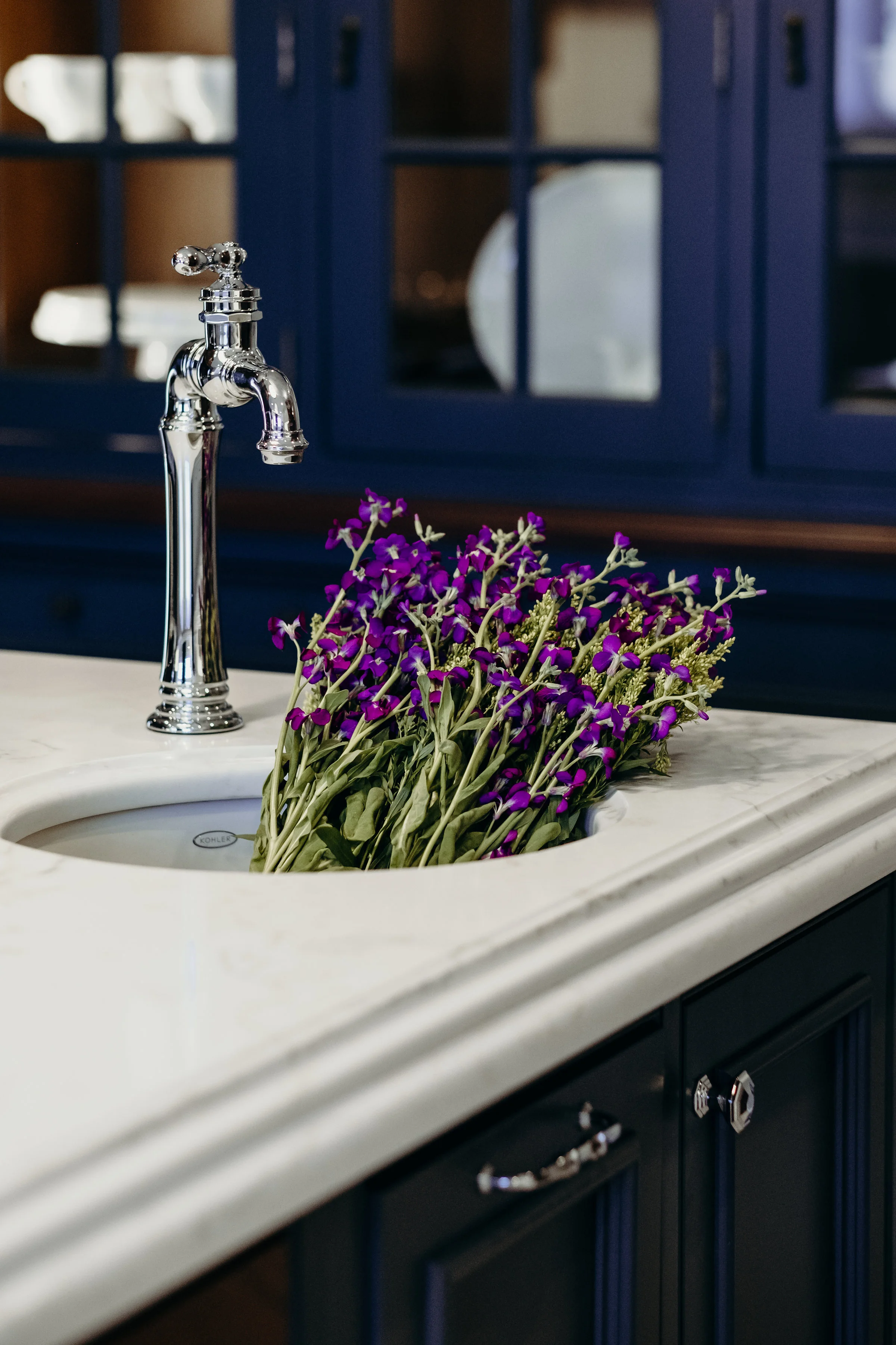 Fresh cut flowers in a french country kitchen with quartz countertops