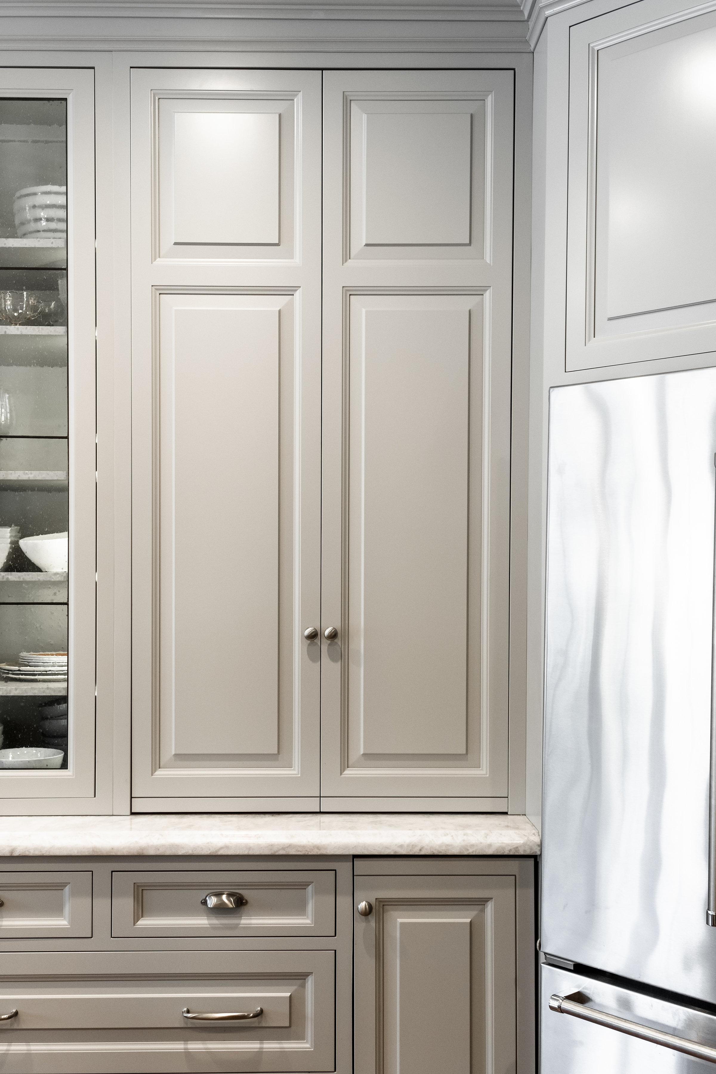 Taupe custom cabinets with chrome hardware