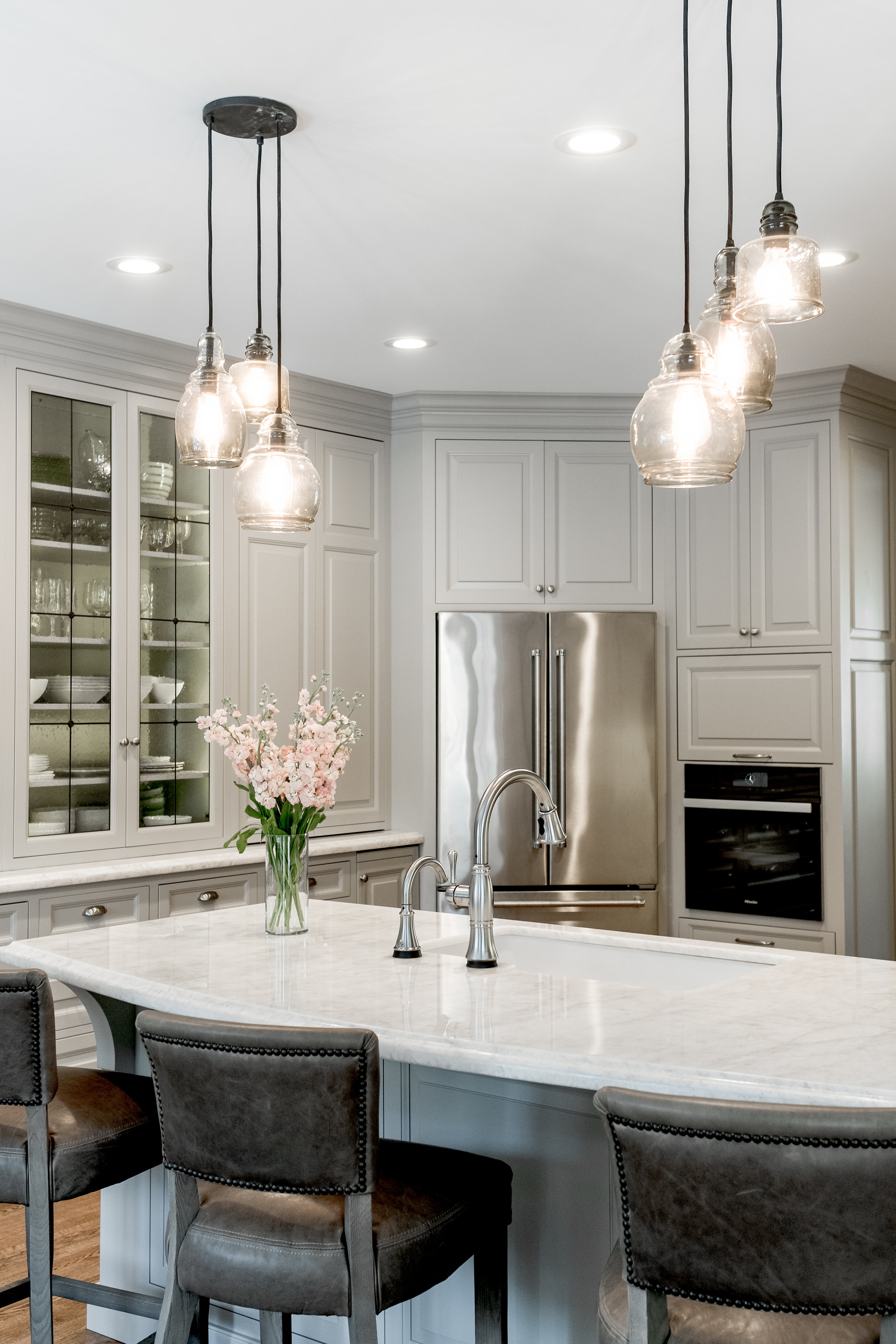 Transitional kitchen with custom cabinets and pendant lighting