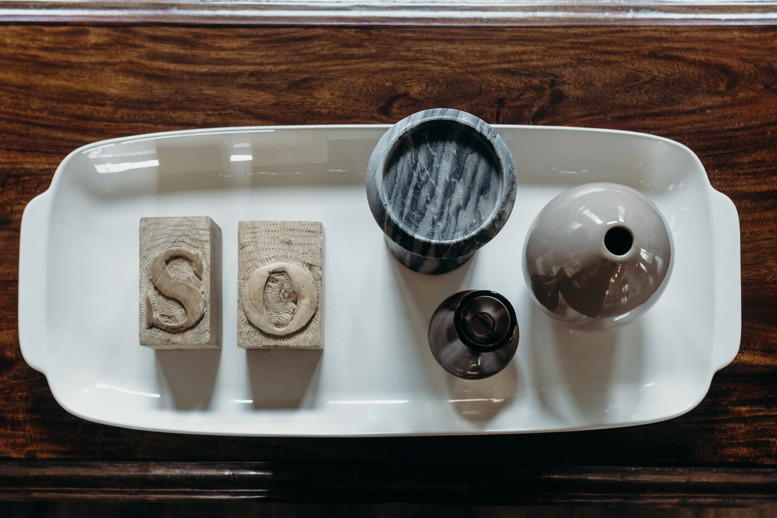 Sofa table styling with marble and ceramic accents