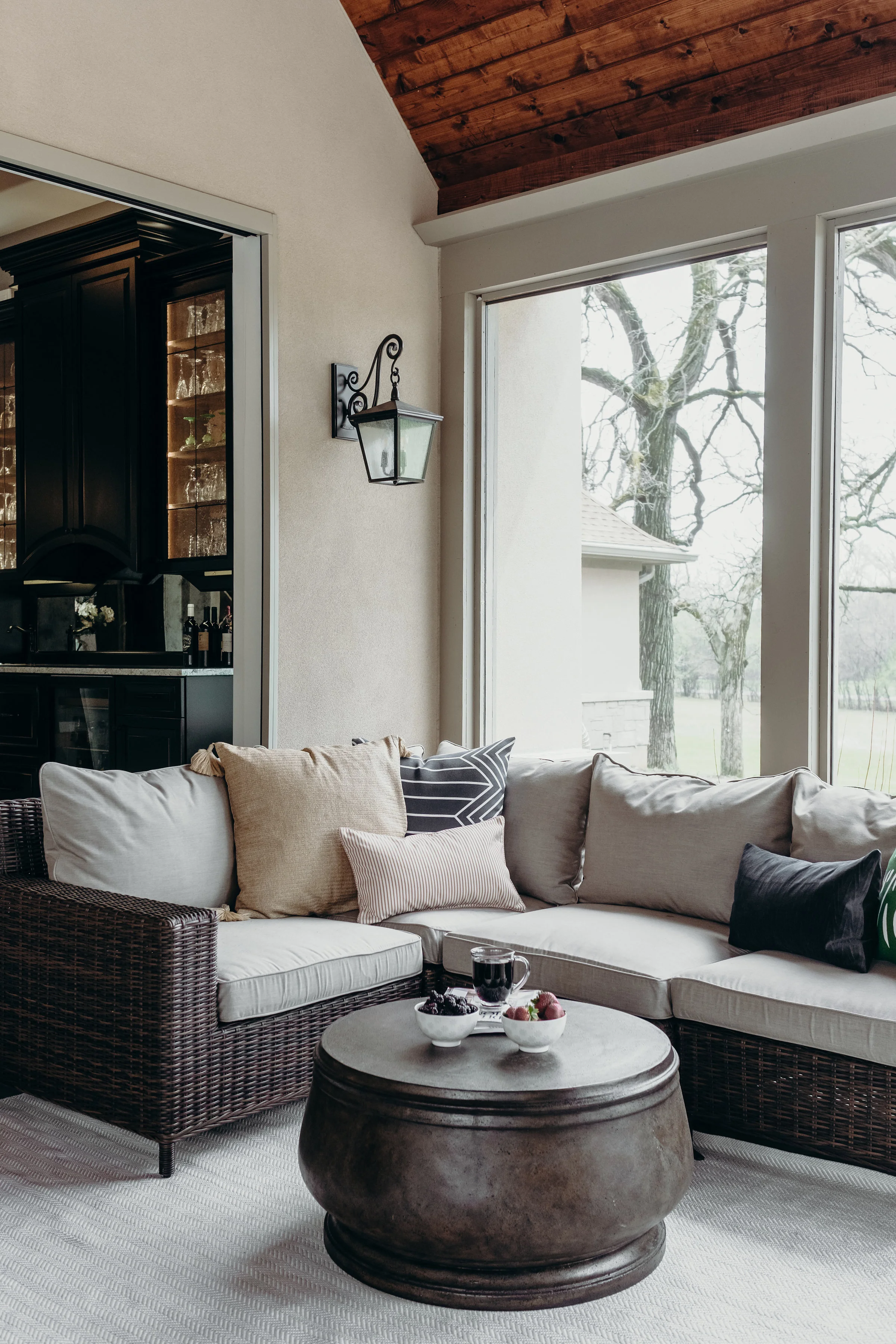 Outdoor sectional sofa with pillows in covered porch