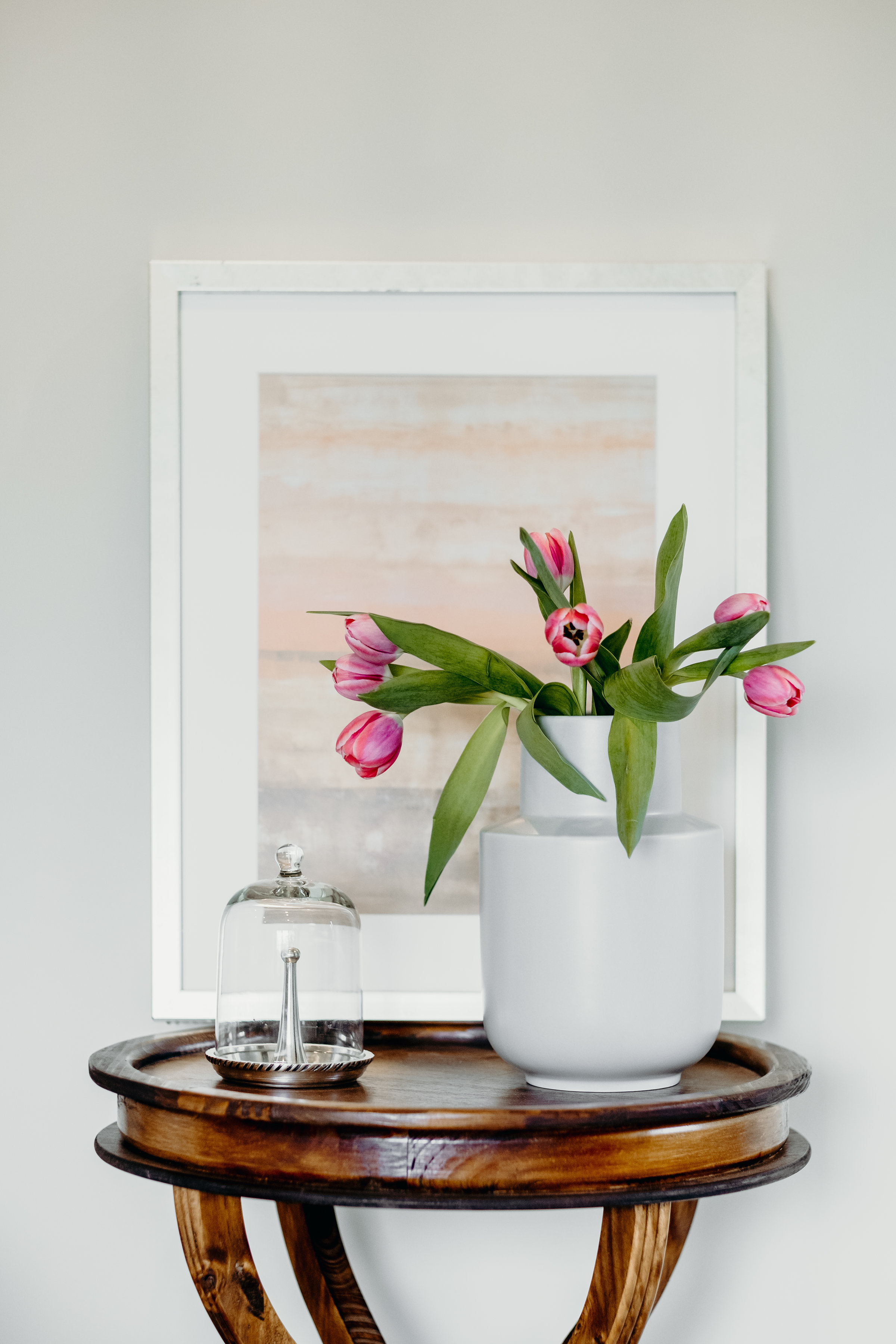Side table styled with flowers and art