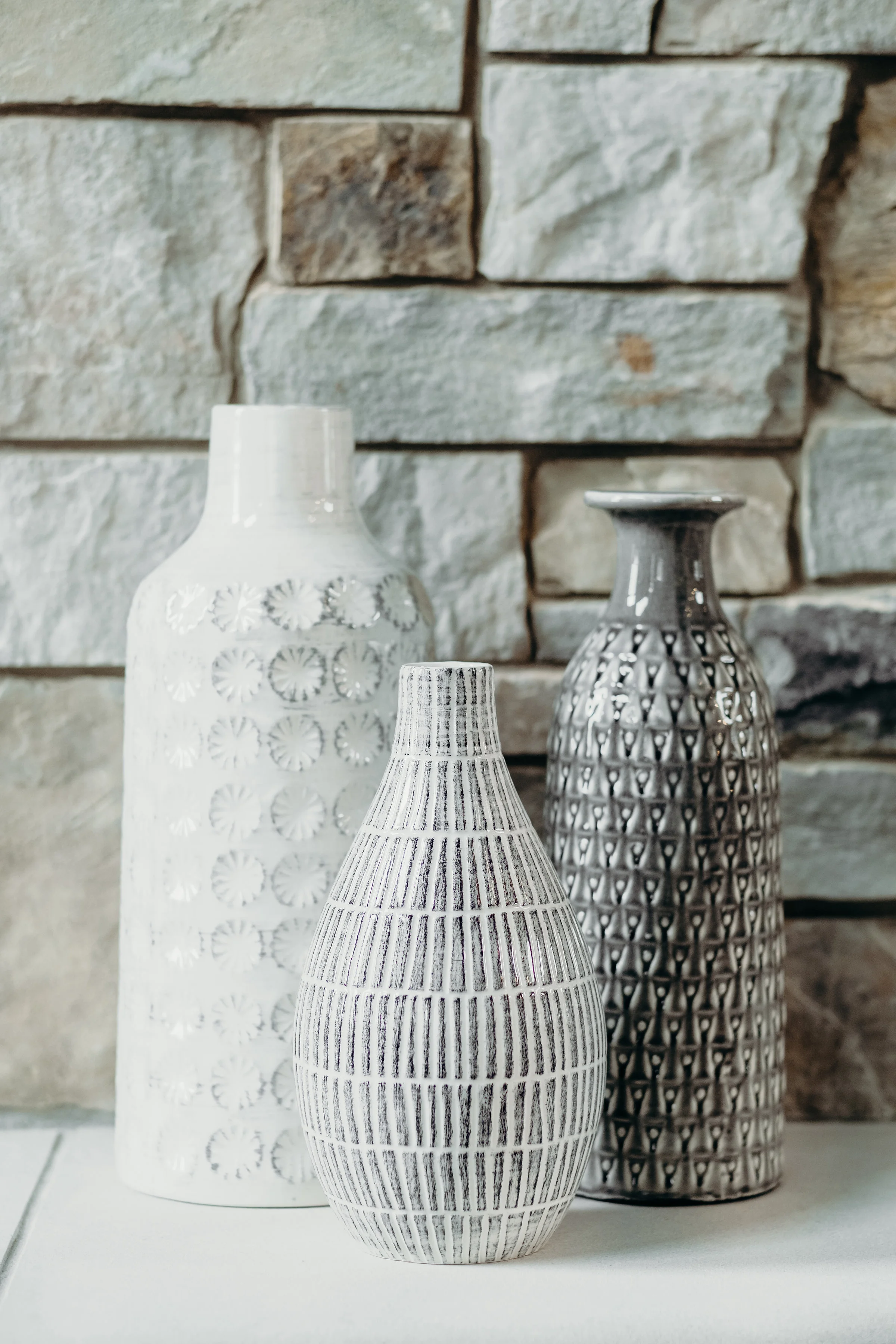 Assortment of Pottery Barn vases on a fireplace