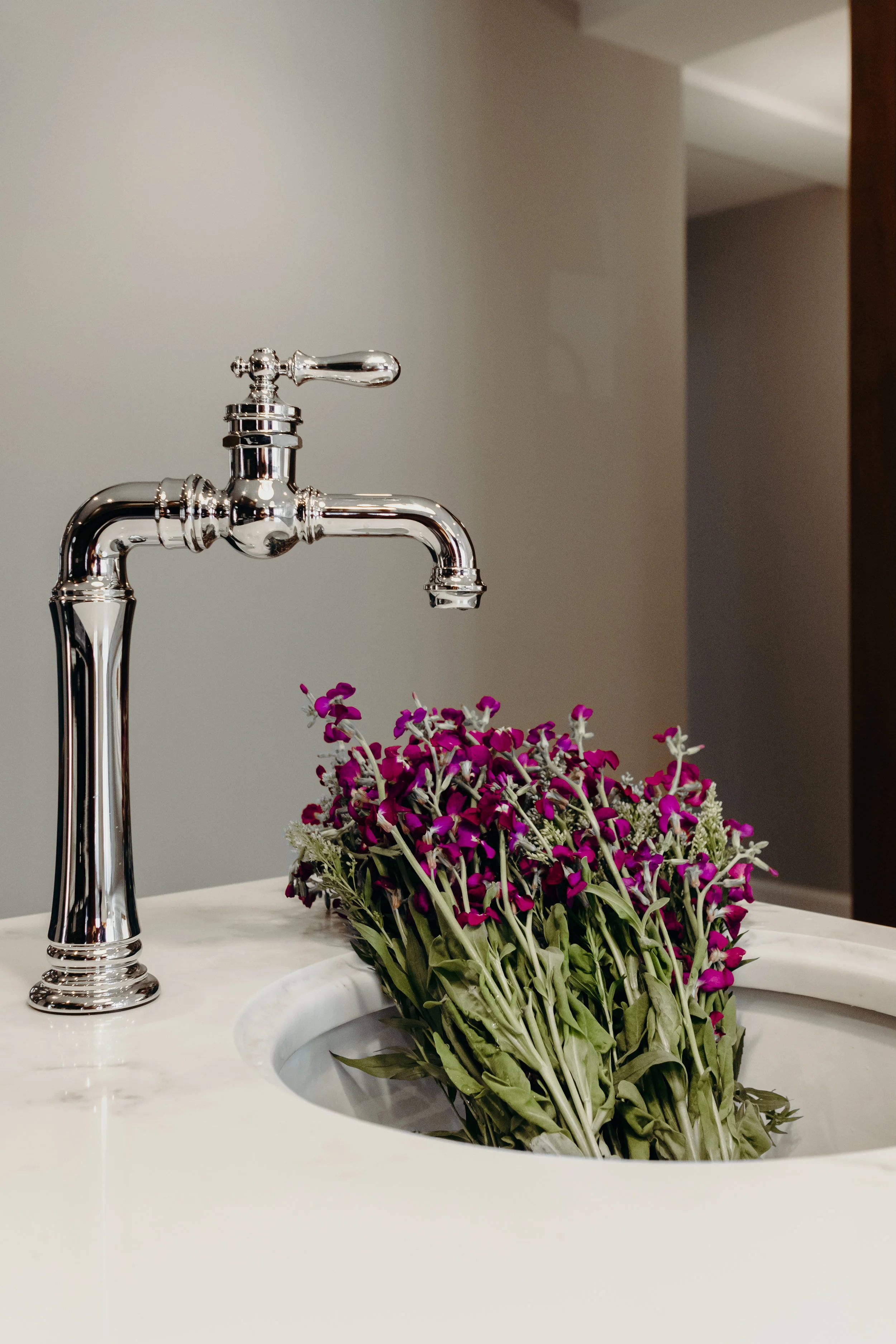 Chrome hardware in kitchen with marble countertops