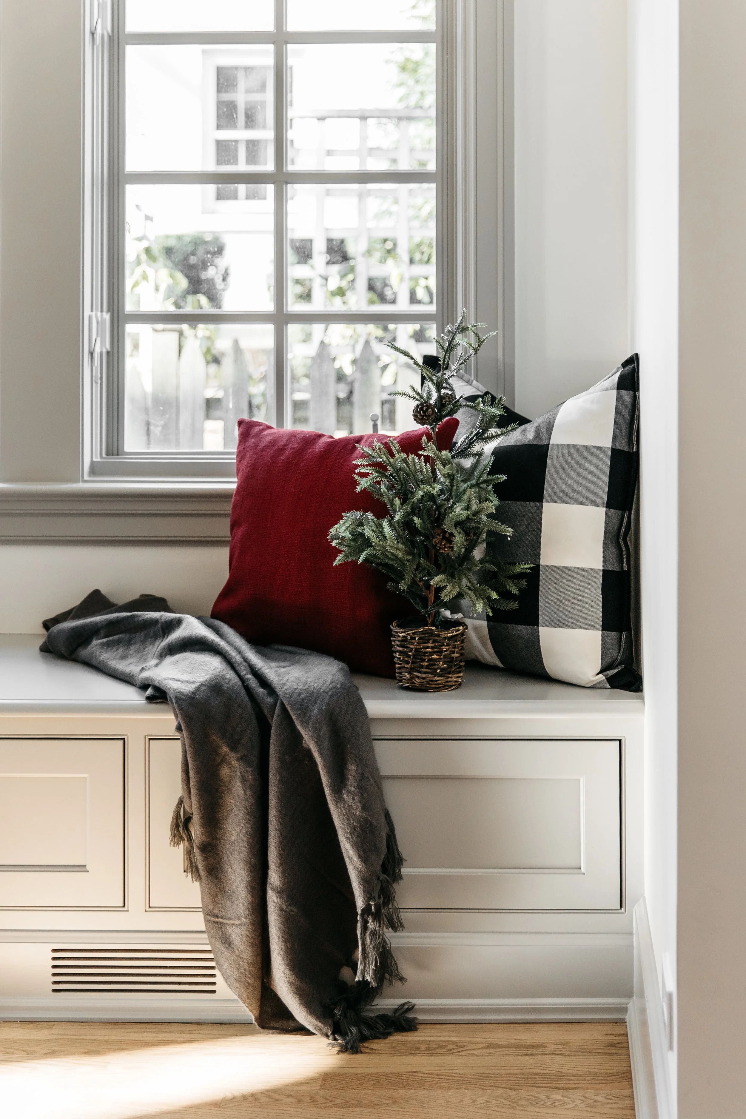 Cozy bench with throw pillows and a blanket