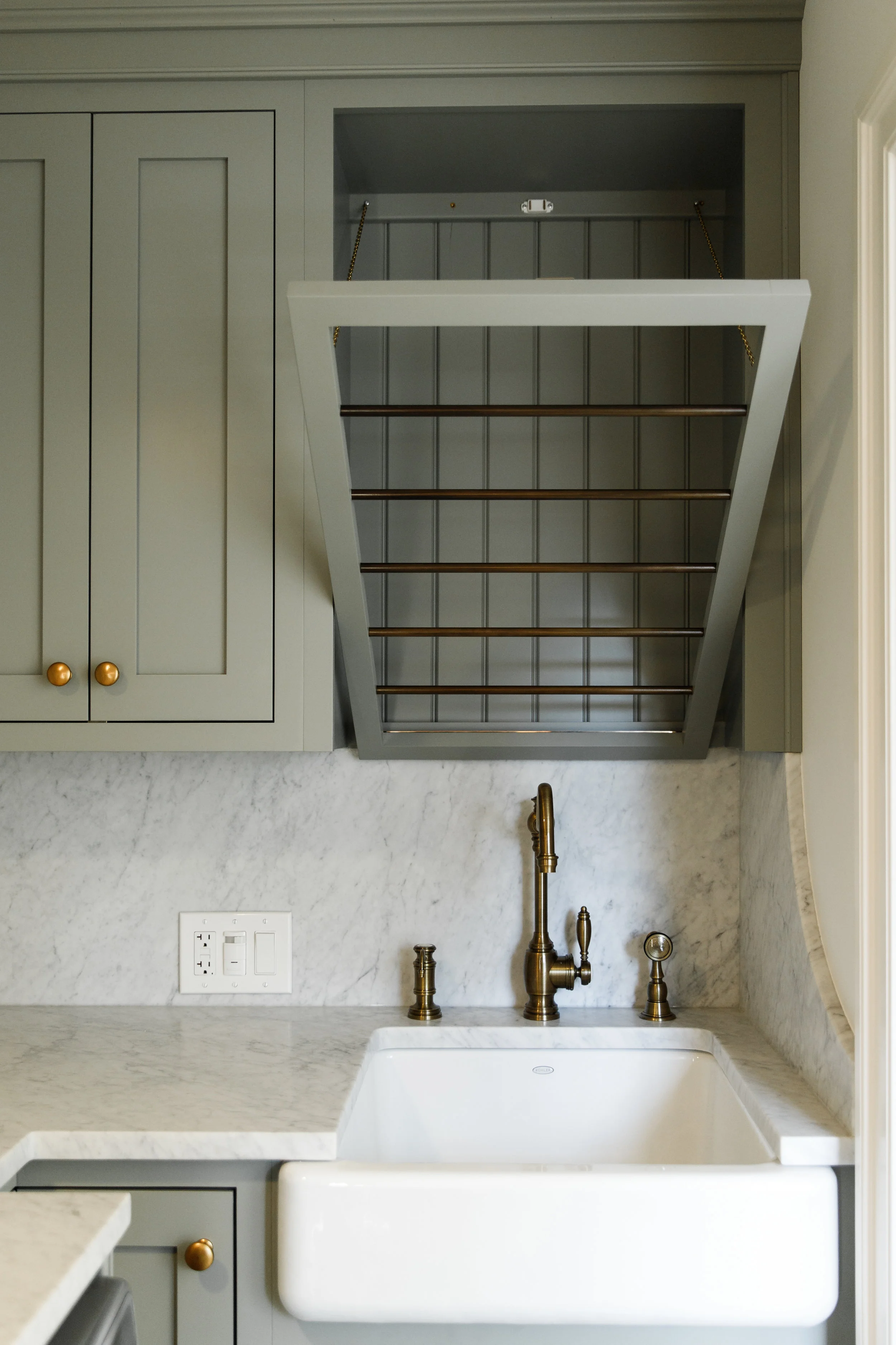 Brass hardware and cabinets painted in Pigeon by Farrow and Ball