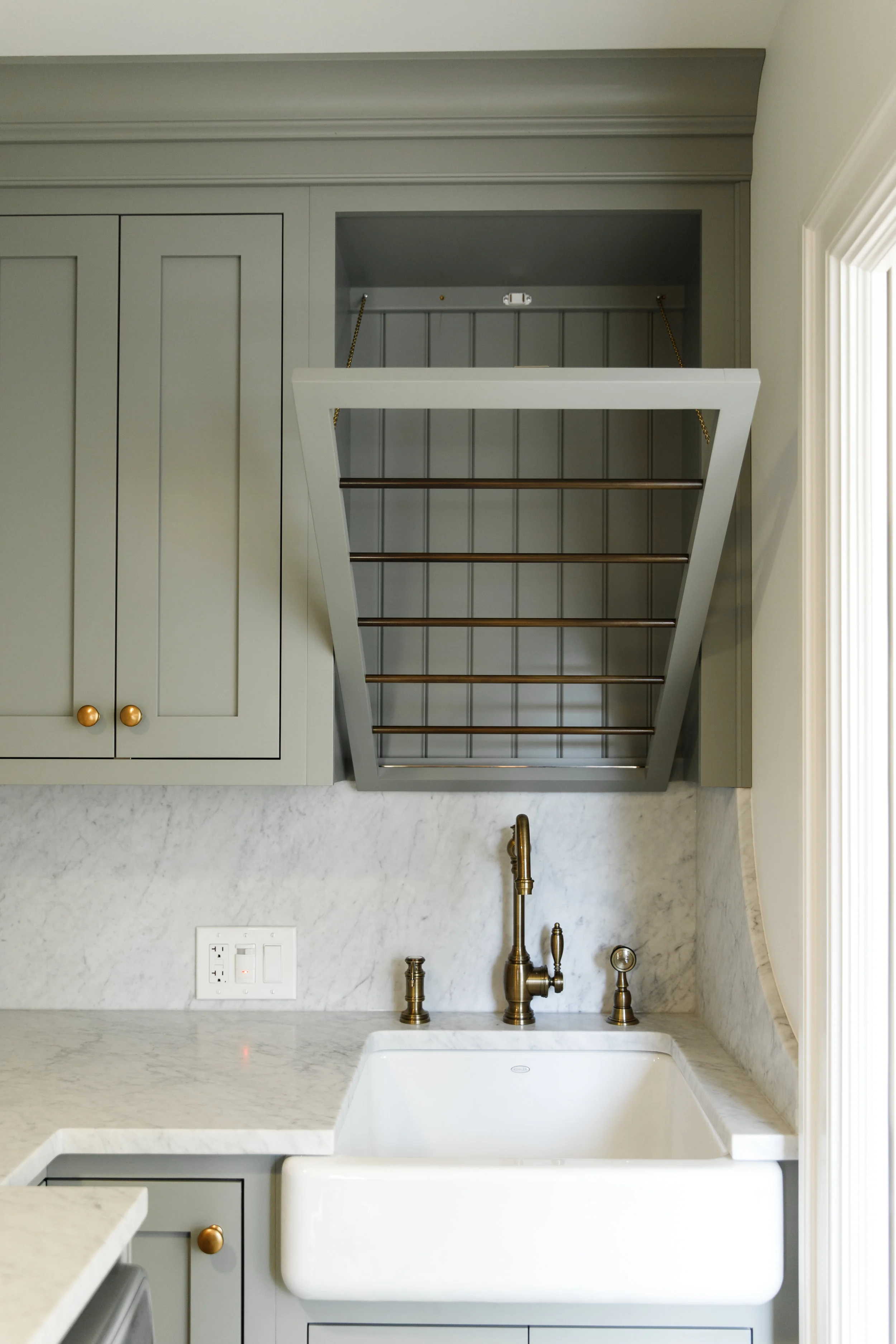 Laundry sink with drying rack and brass hardware