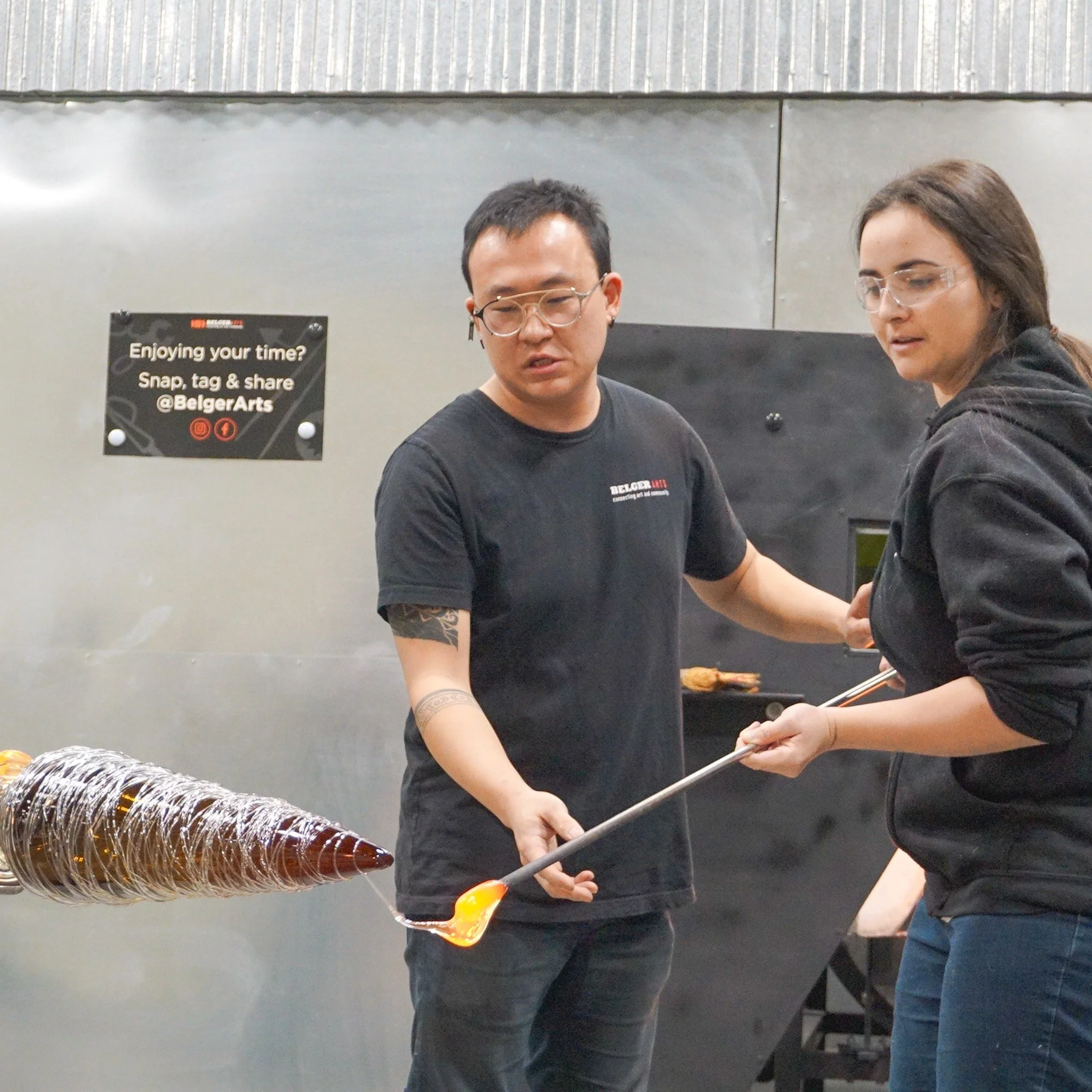 Crowd participating in wrapping Christmas Tree in (glass) tinsel