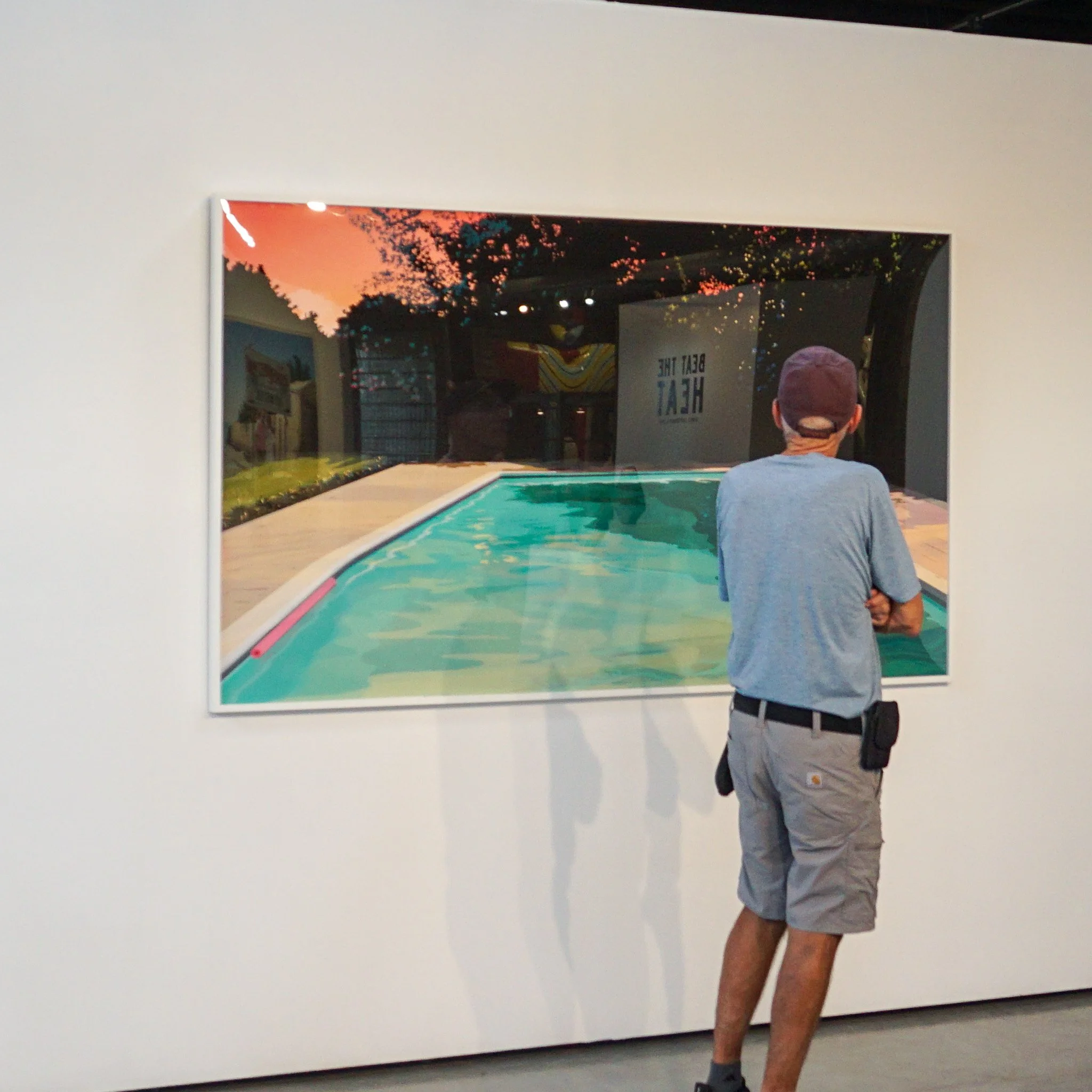 Visitor viewing "Float" by Robert Bingaman, featured in "Beat the Heat"