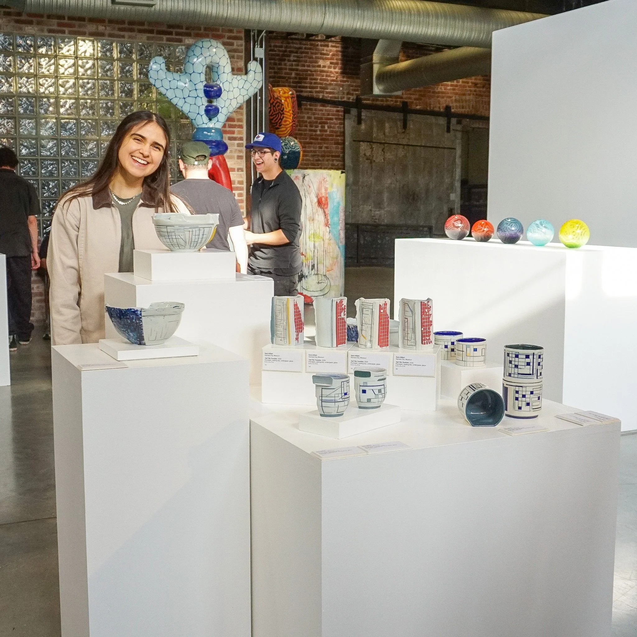 Resident Sara Alfieri with her work featured in "Proximity and Practice"