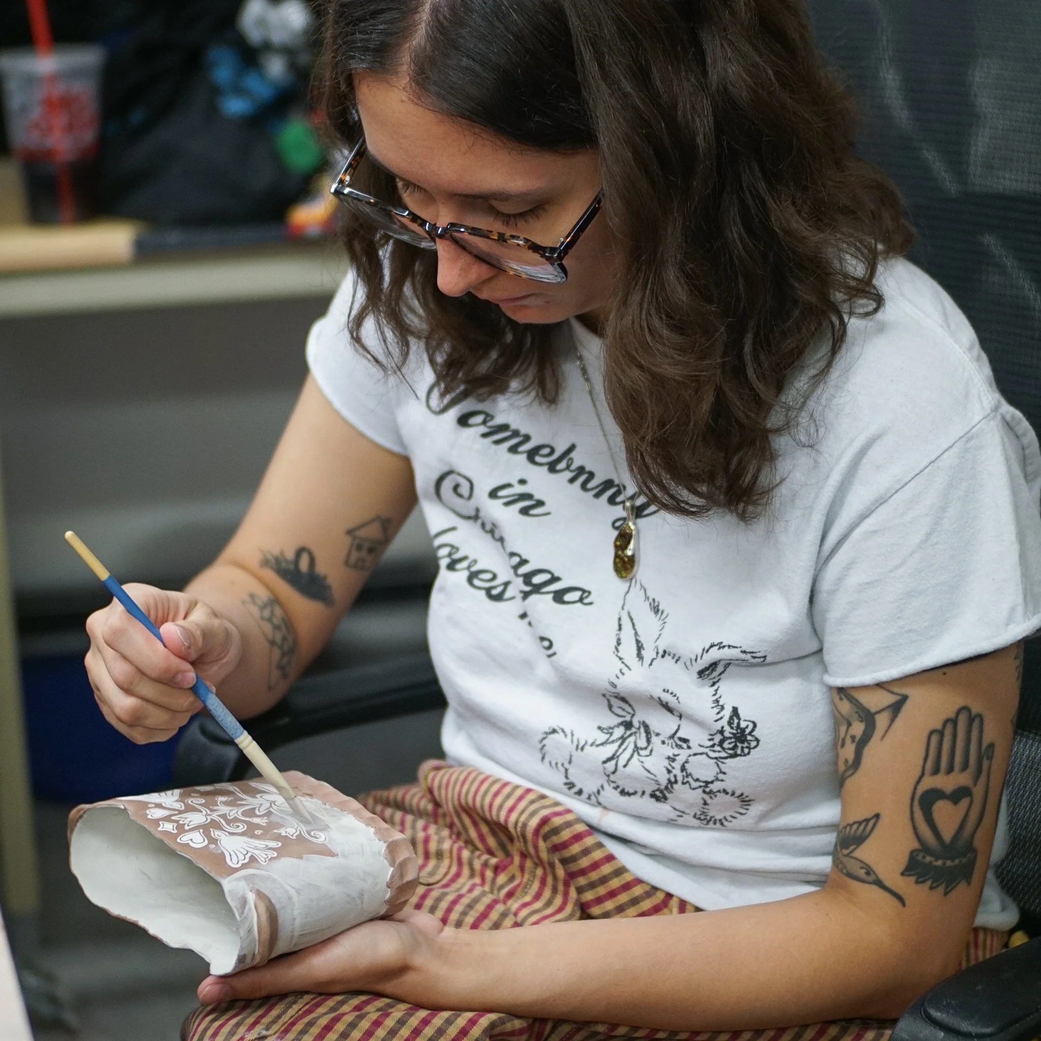 Resident Artist Zoey McLeod sgraffitoing her hand built ceramic baskets