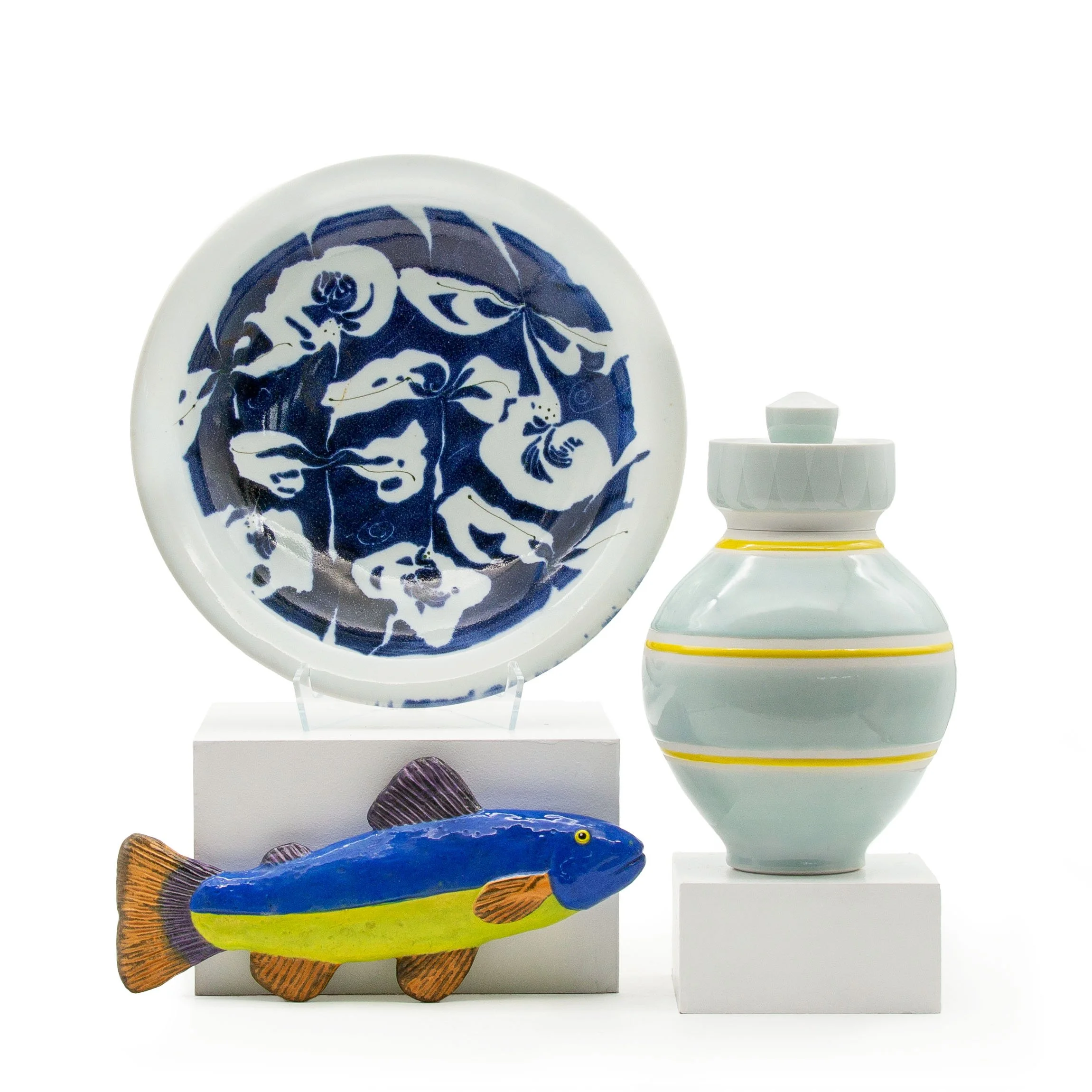 Clockwise from top left:&nbsp;Deborah Wald, “Platter“; Paul Donnelly, “Lidded Jar,” ; Marilyn Lysohir, “Victor's Fish”. Courtesy of Victor Babu's Ceramics Collection. Photograph by Belger Arts.