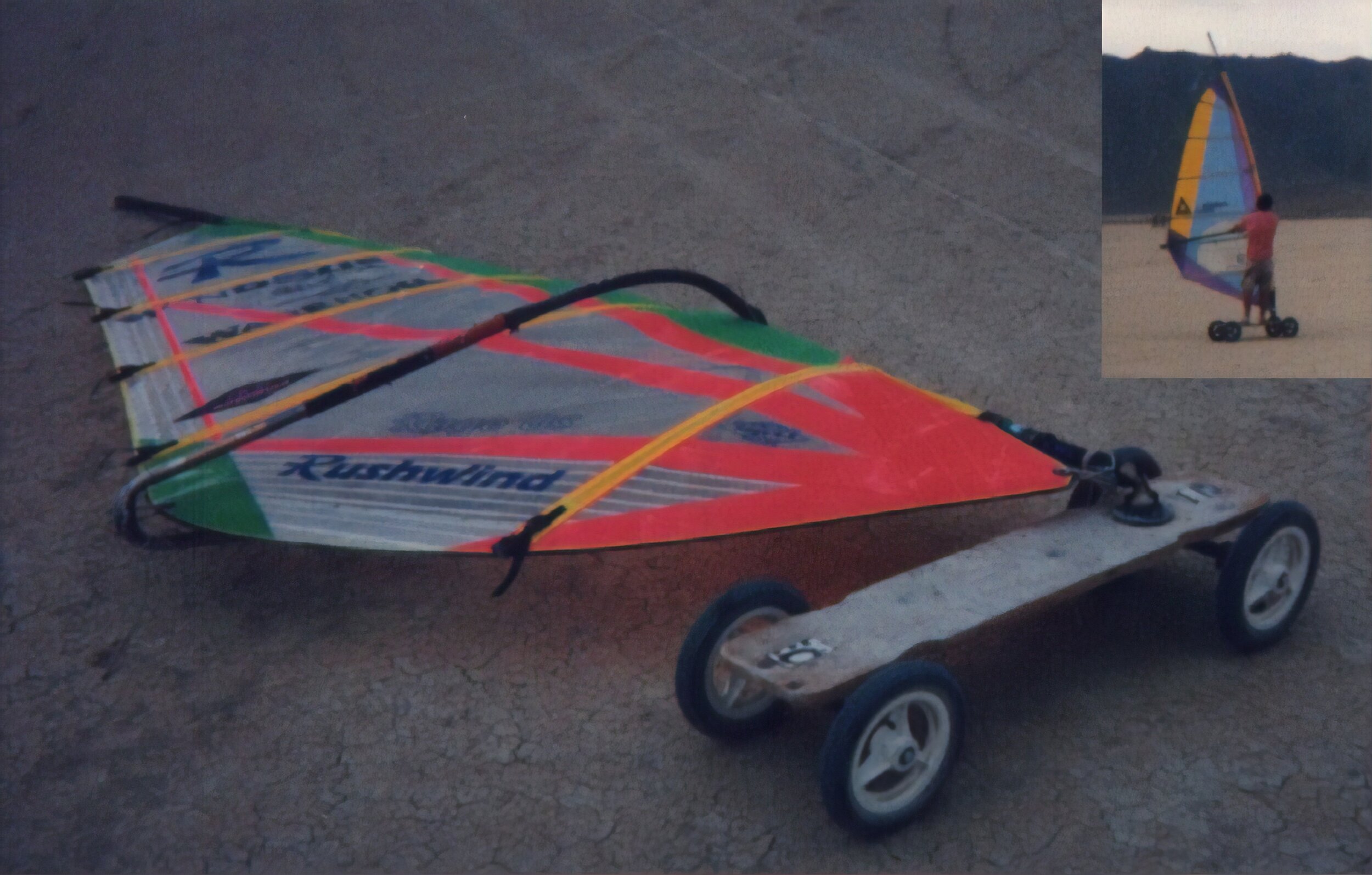  A standard windsurfer sail mounted on a skate board. 
