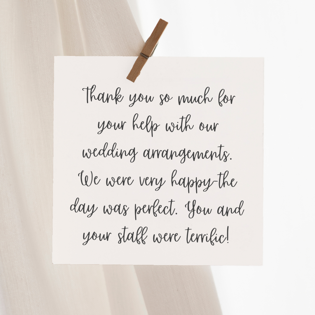 A thank you note hanging on a string with a clothespin. The note thanks someone for their help with wedding arrangements.