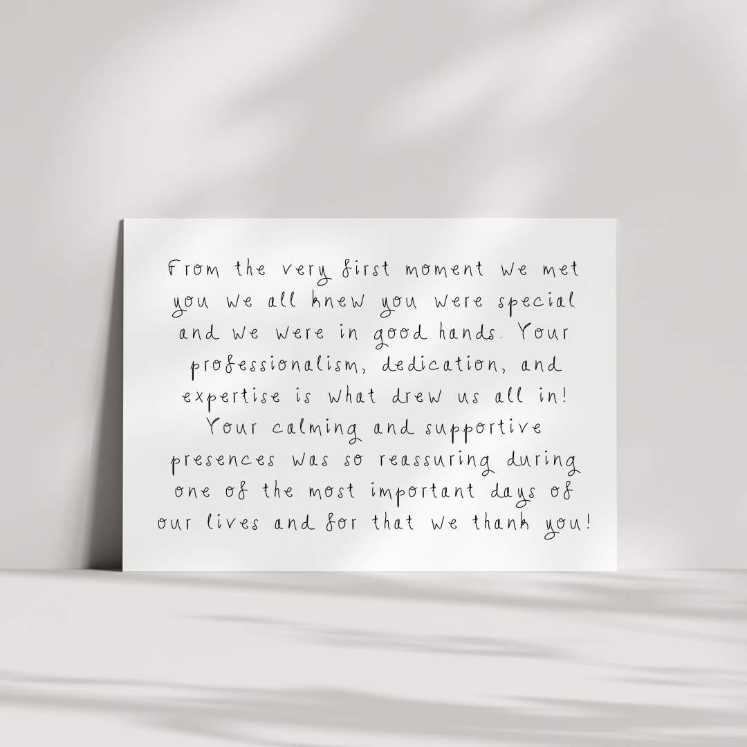 A white card with printed handwritten-style text placed on a flat surface, with a soft shadow cast behind it, against a light gray background.