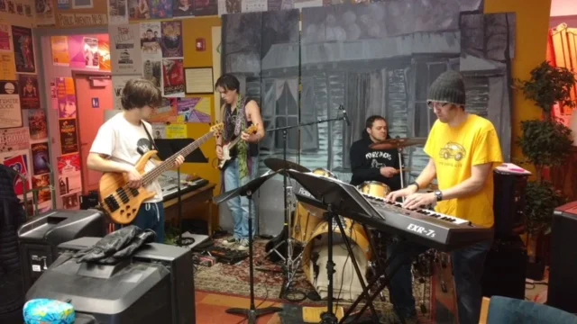 Band with cabin backdrop.JPG