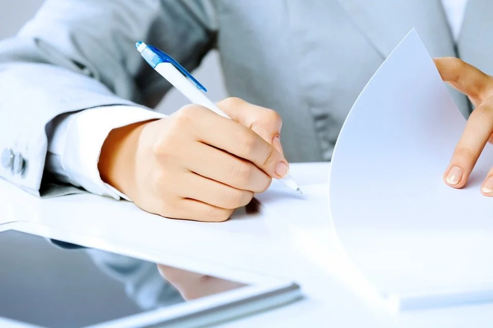Close up image of businesswoman hands signing documents.jpeg