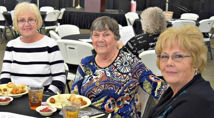 Three people eating at the table