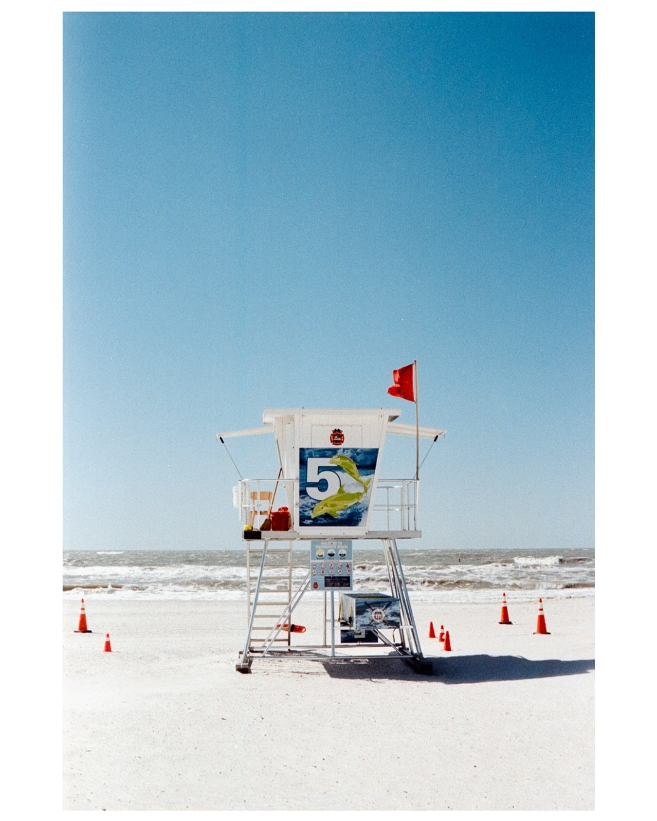 I braced myself; the wind whipping the sand against my legs, feeling like tiny needles. The beach mostly empty save for a few desperate sun seeker and me, desperately hoping this portrait of a lifeguard stand would turn out the way I was seeing it. I